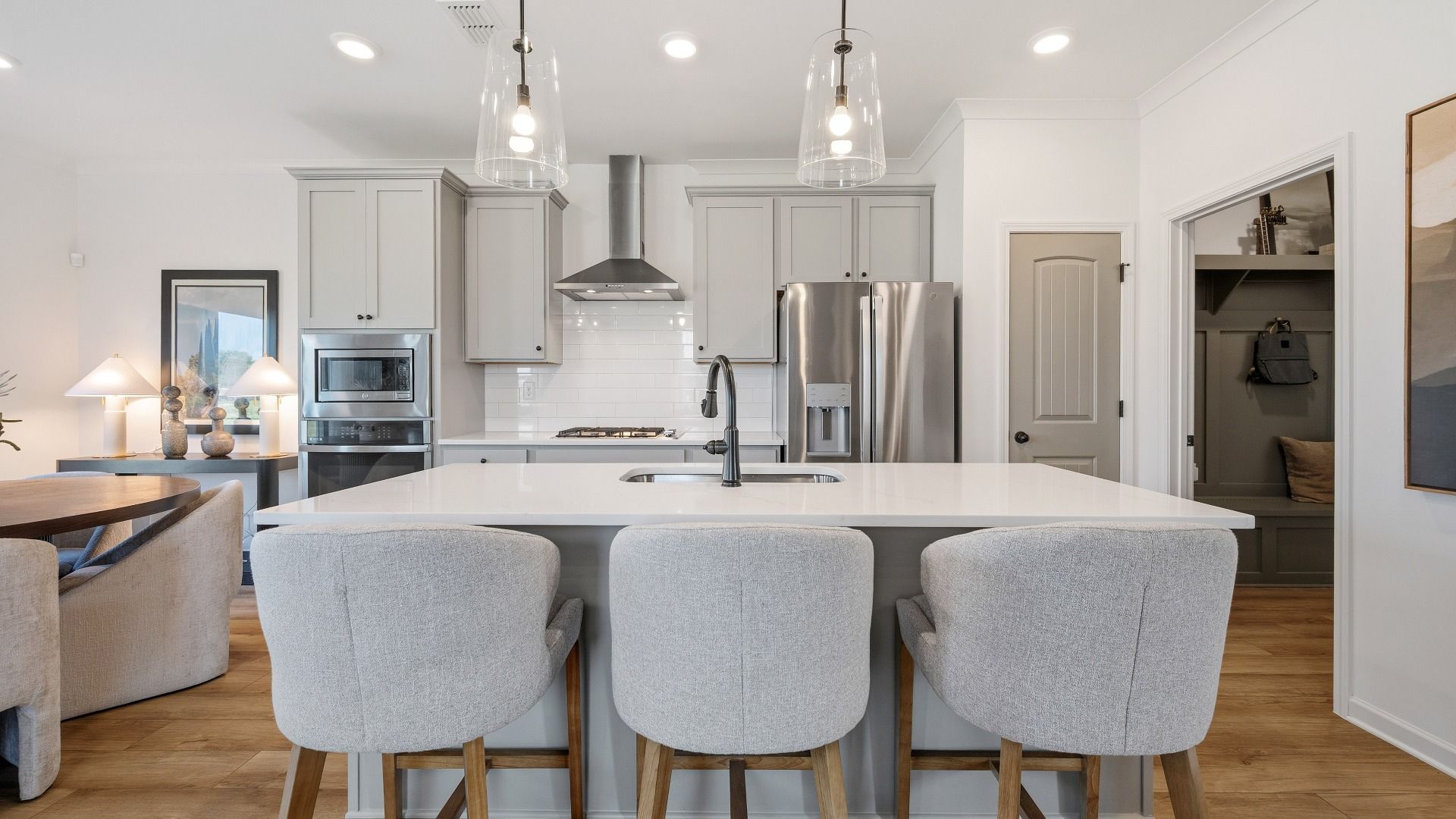 Spacious kitchen with center island and stylish cabinetry in Langley Overlook new construction townhome in Loganville, GA.