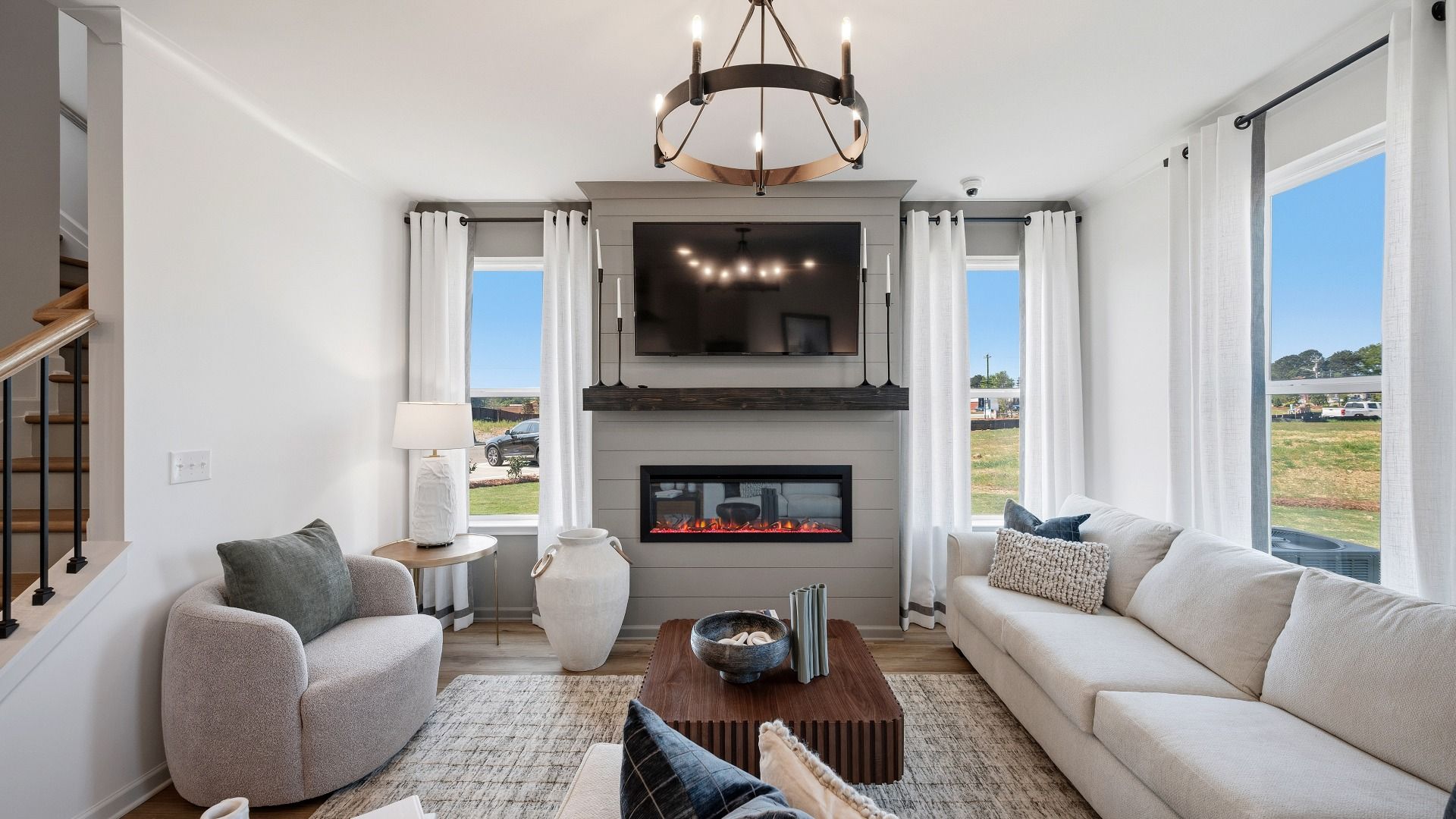Inviting family room with open concept design and abundant daylight in new construction townhome in Loganville, GA.