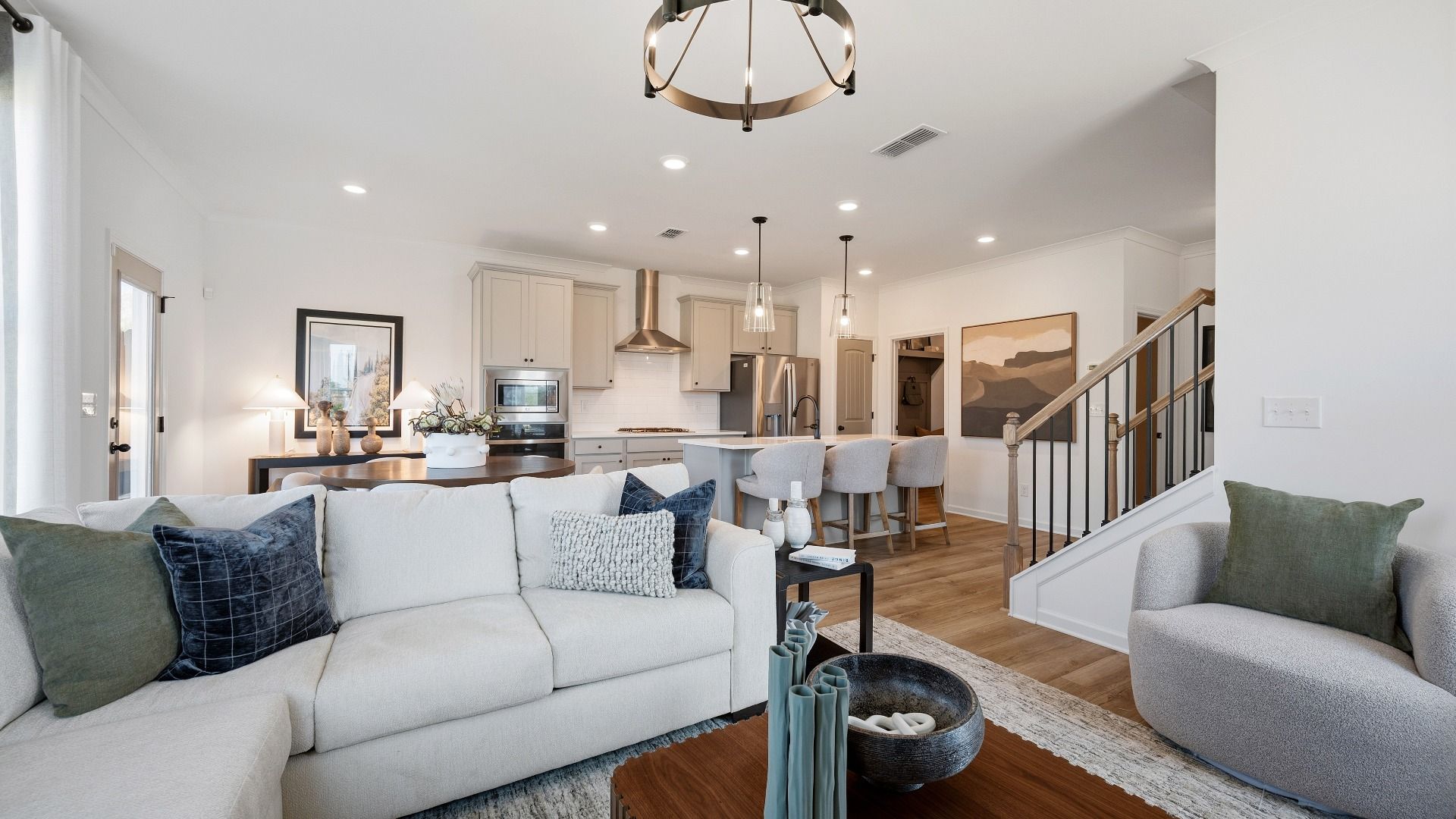 Open family room with seamless flow to kitchen and abundant natural light in Langley Overlook townhome in Loganville, GA.