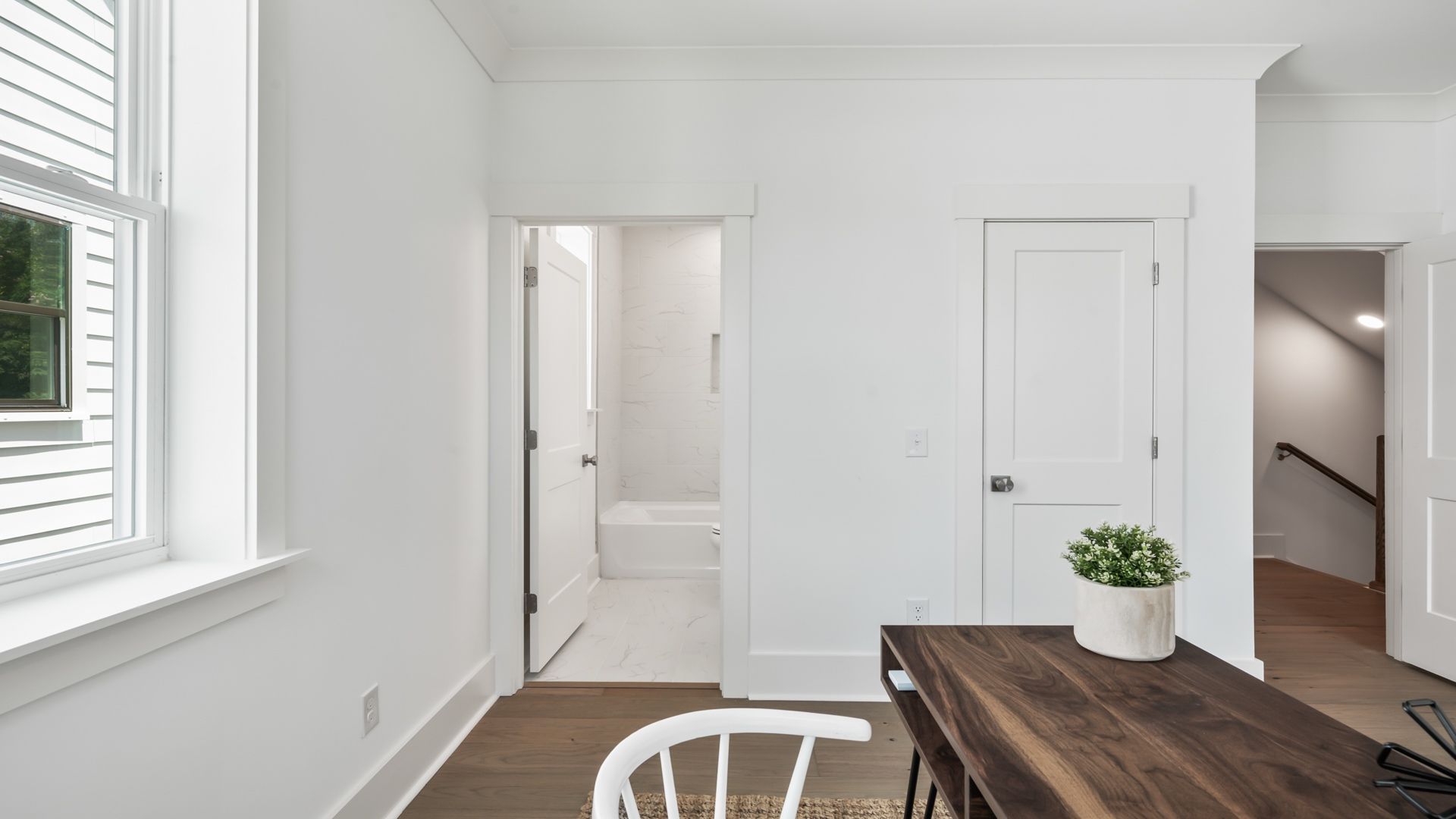 Secondary bedroom in the Sullivan home plan featuring natural light and convenient access to an attached bathroom.