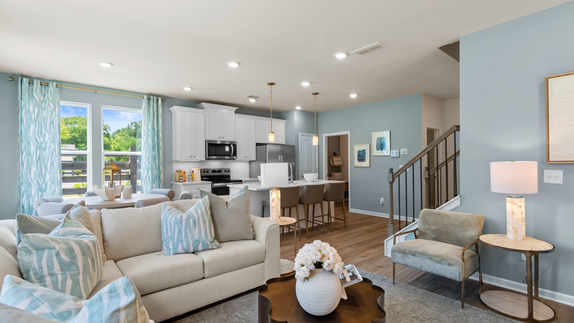 Open concept kitchen and family room in new construction townhome with seamless flow and natural light.