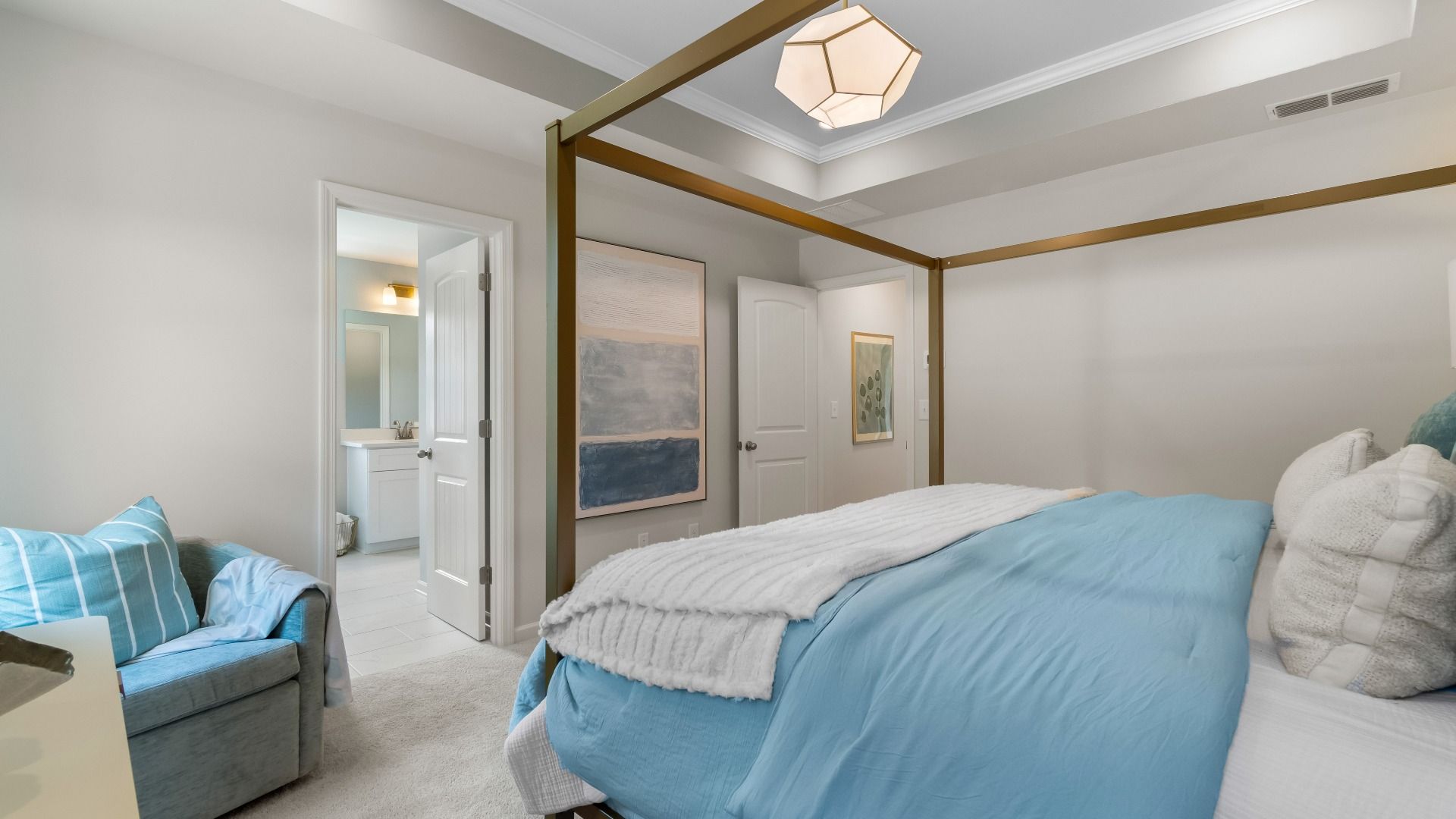 Stylish primary suite in new construction townhome featuring soft textiles and calming neutral palette.