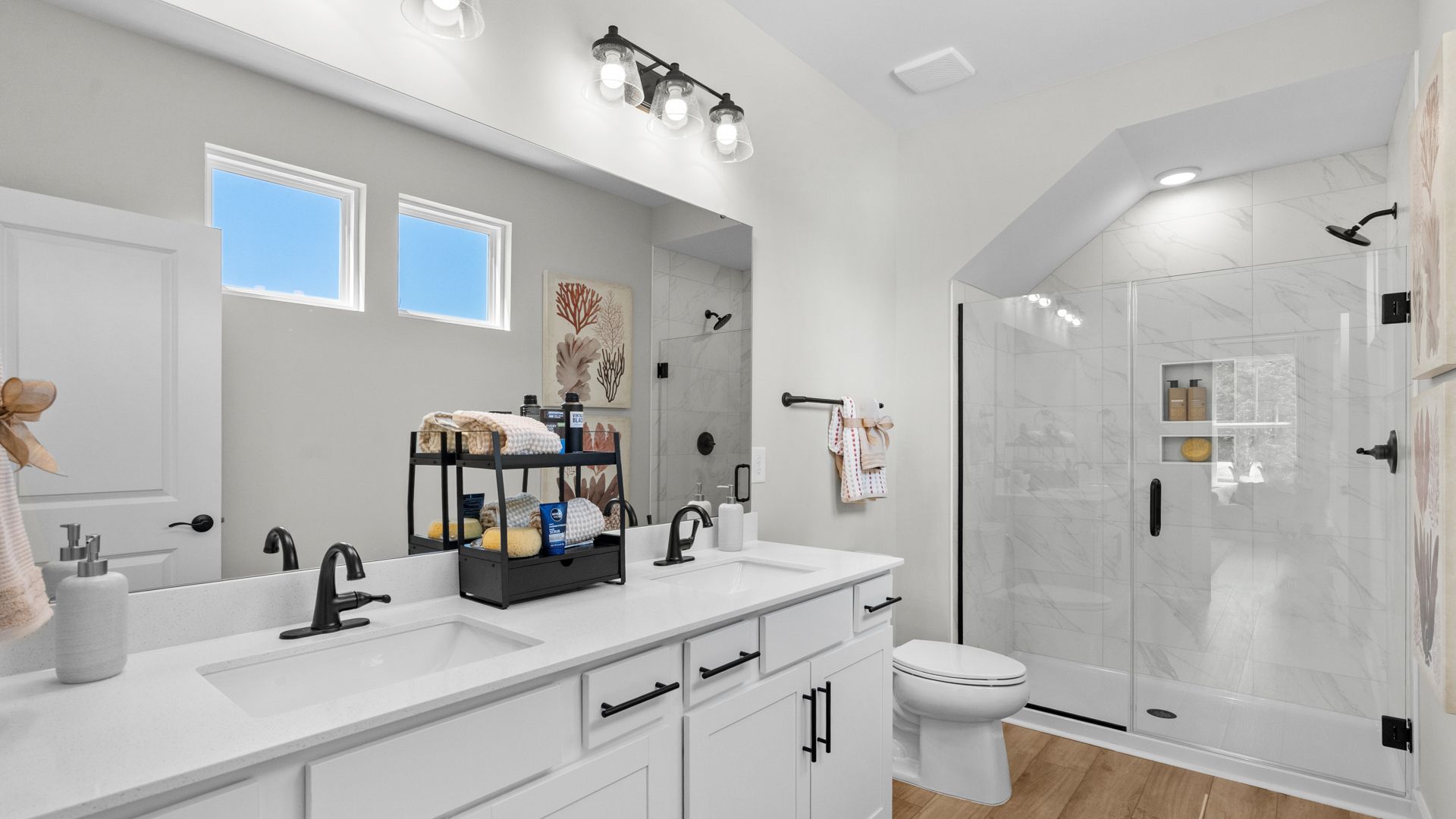Primary bathroom in the Summit home plan with modern finishes and dual vanities.