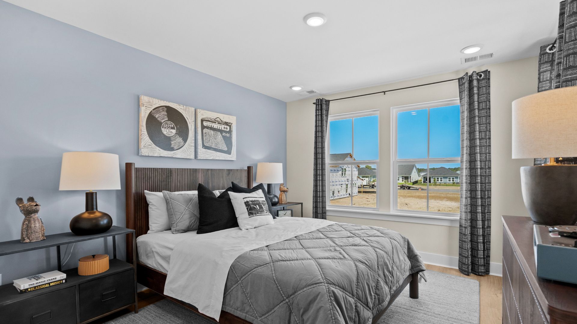 Second-floor secondary bedroom in the Summit home plan with bright windows and comfort.