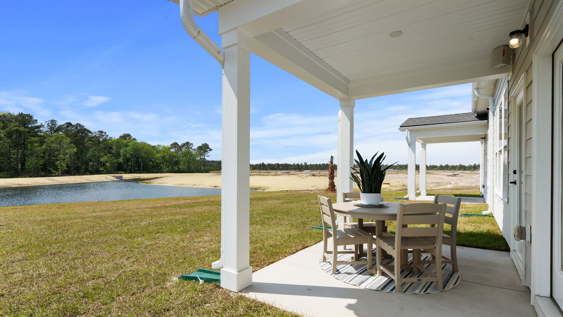 Covered rear porch in the Summit home plan offering outdoor living and relaxing views.
