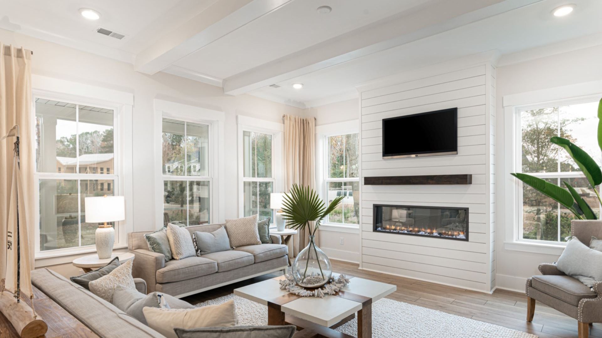 living room with shiplap gas fireplace