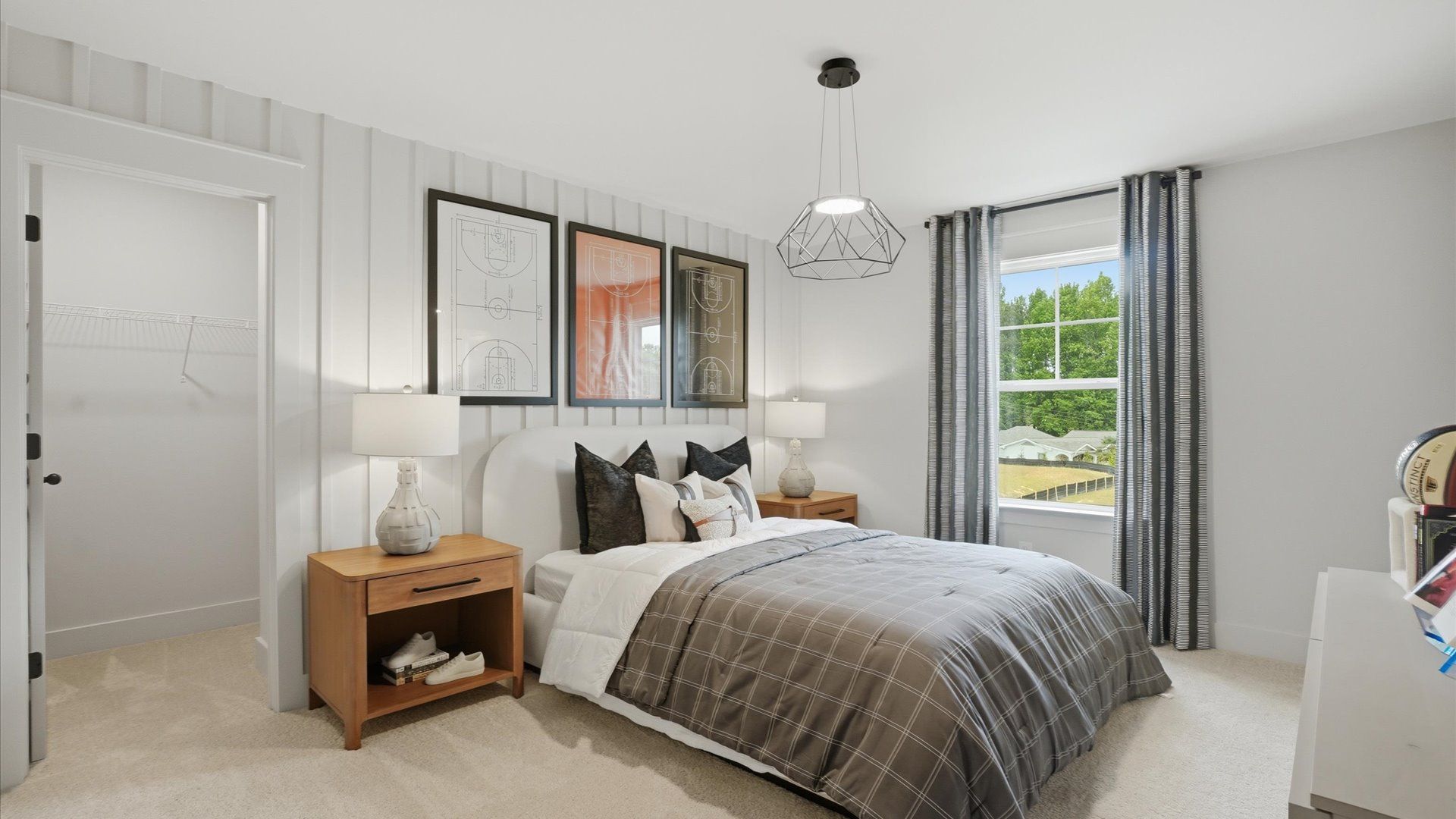 Secondary bedroom with carpet flooring and walk-in closet at Northcroft in Loganville, GA.