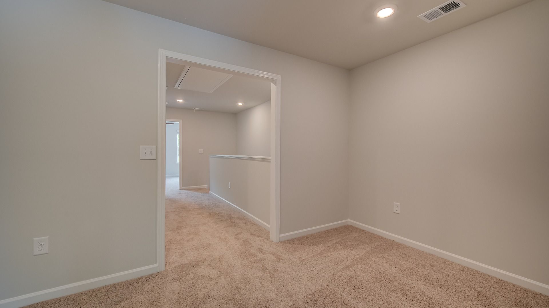 Loft for flexible use with open doorway and carpet flooring in the Mitchell at Avery Landing in McDonough, GA.