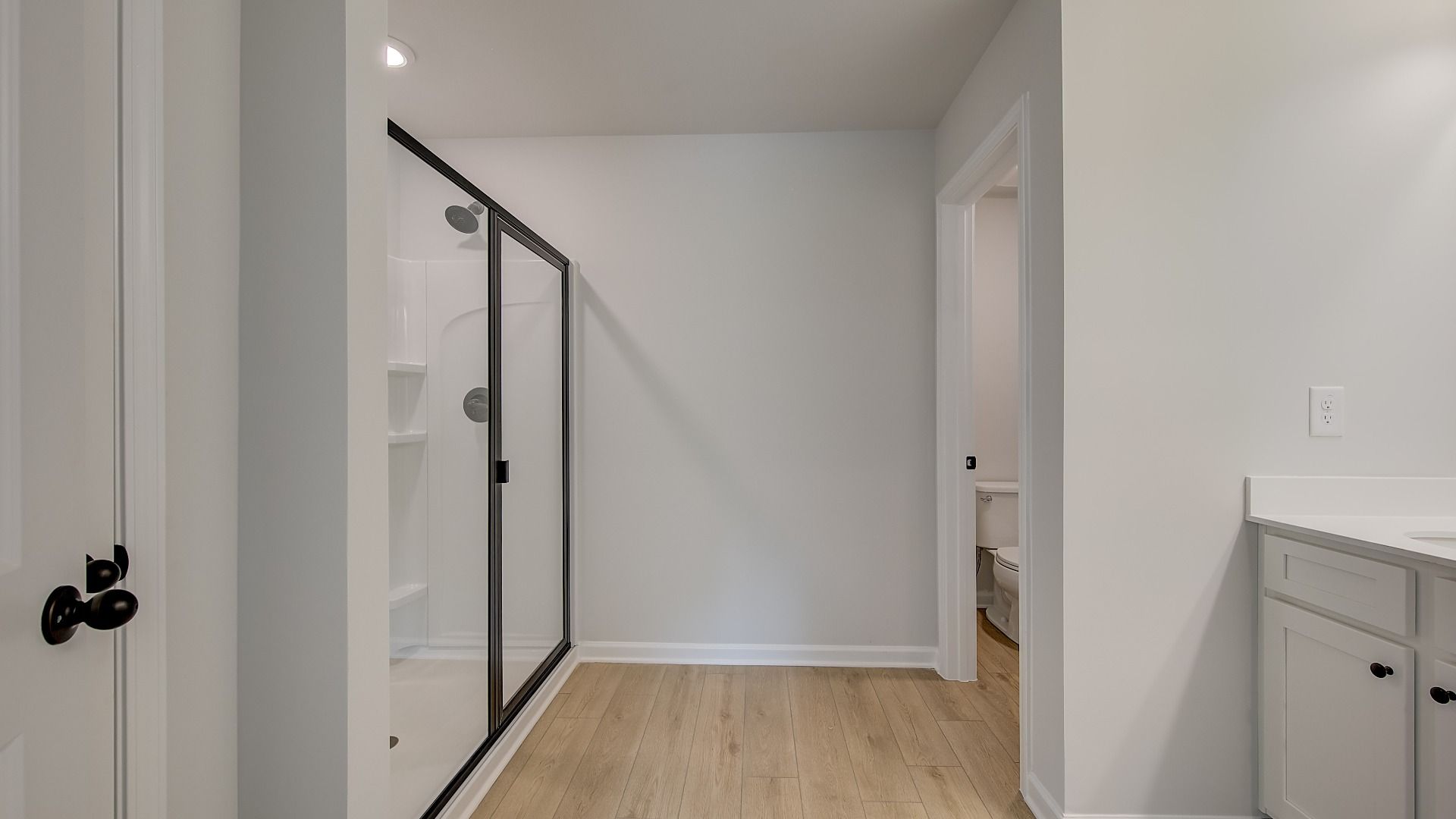 Primary bath with walk-in shower, closet, and clean modern finishes in the Mitchell at Avery Landing.