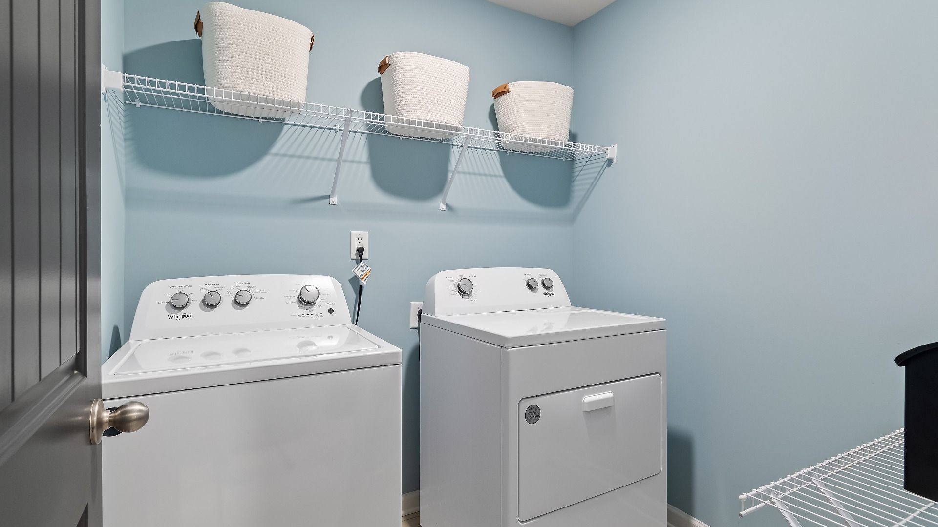 Upstairs laundry area with a shelf in new construction townhome at Avery Landing in McDonough, GA