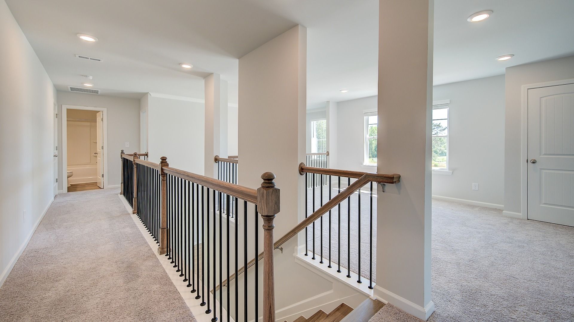 Clarity upstairs landing with carpet flooring and loft entry at Brighton in Locust Grove, GA.