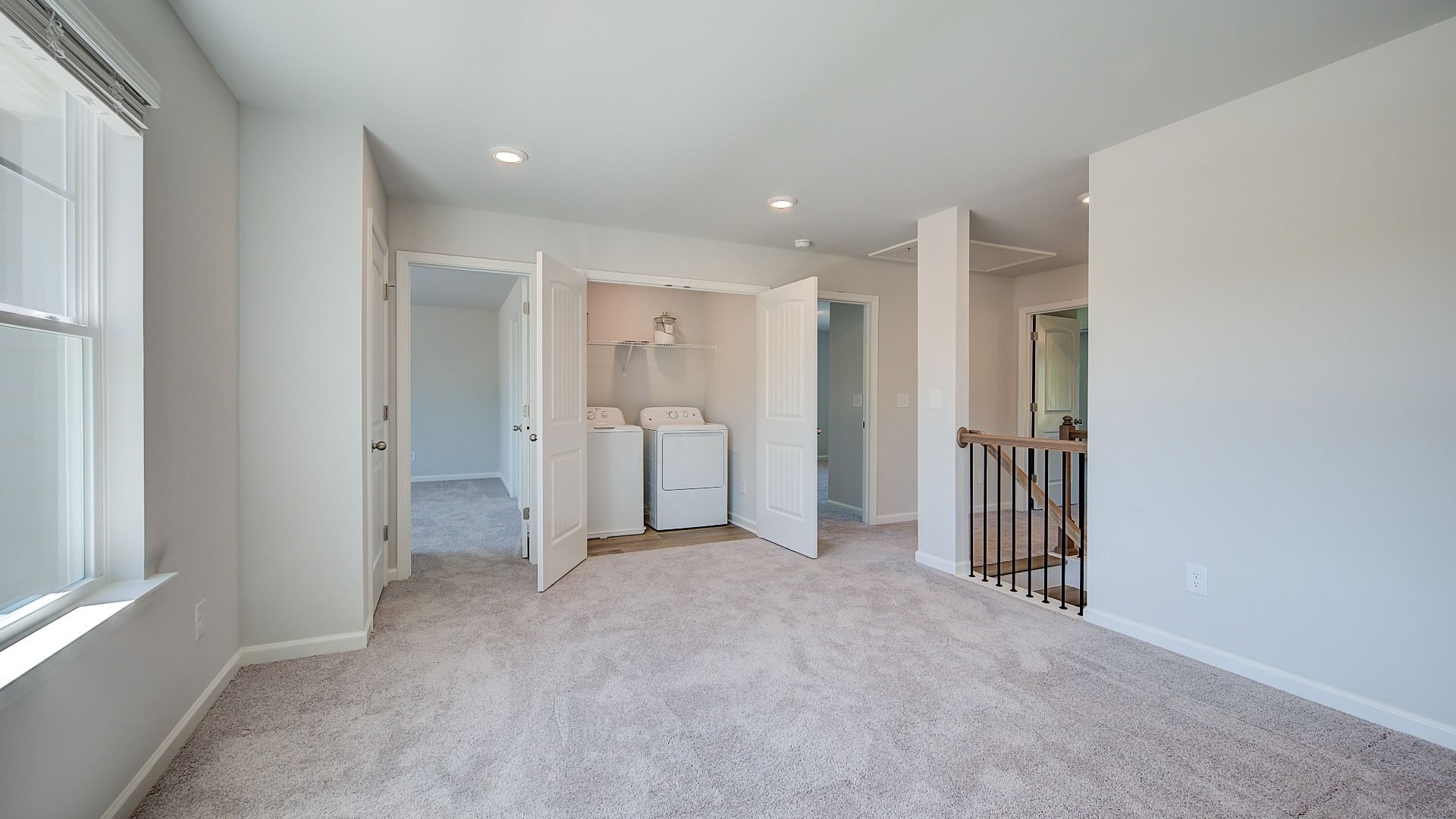 Versatile Clarity loft with carpet flooring and laundry room access at Brighton in Locust Grove, GA.
