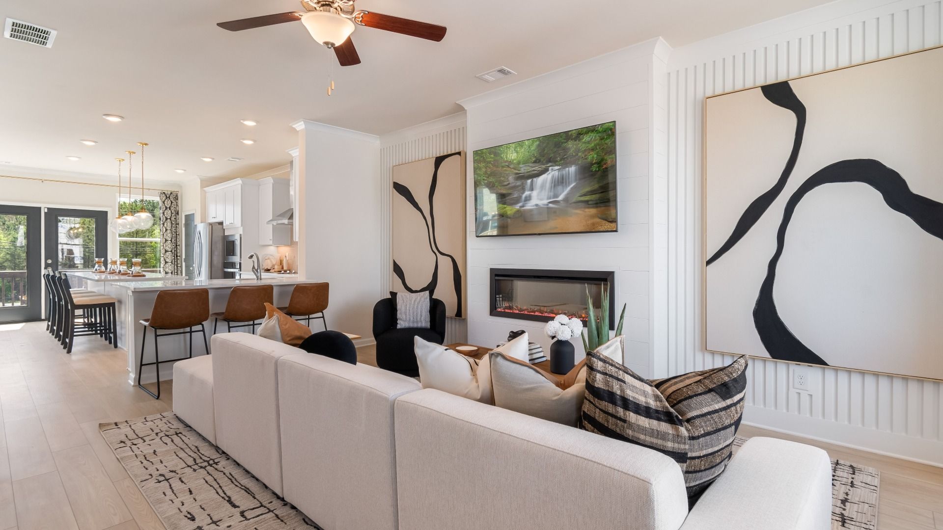 Open floorplan seamlessly connecting the family room and kitchen area for luxury easy living at Silverock in McDonough, GA.