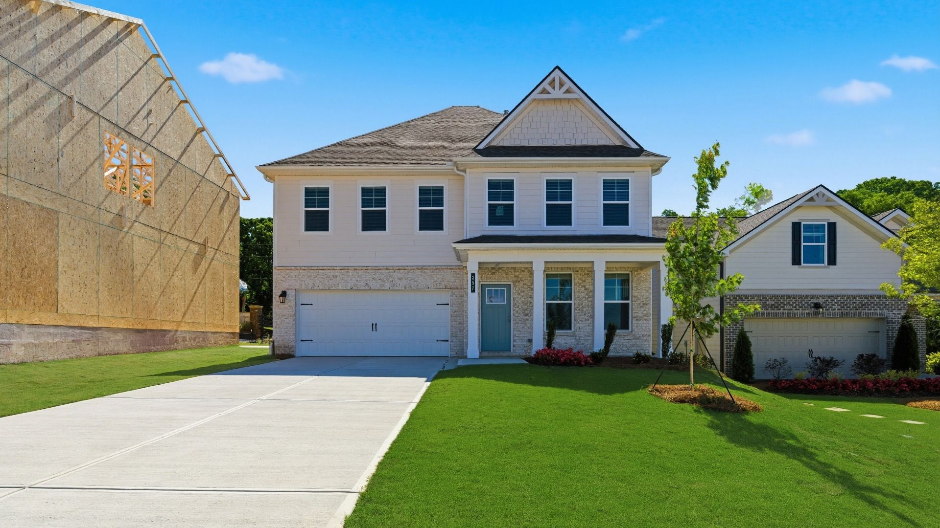 Wynwood elevation 8 exterior first level light brick with siding second level and front-entry garage at Abbotts Crossing.