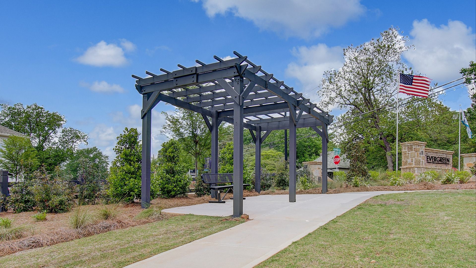 Community gazebo with bench seating at entrance to Enclave at Evergreen new construction single family home community.