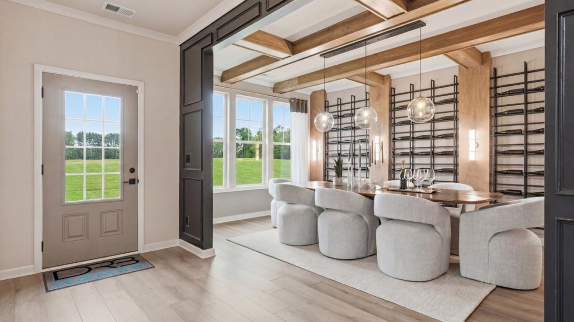 Stonefield foyer with LVP flooring leading to dining room with contemporary finishes at Brighton in Locust Grove, GA.