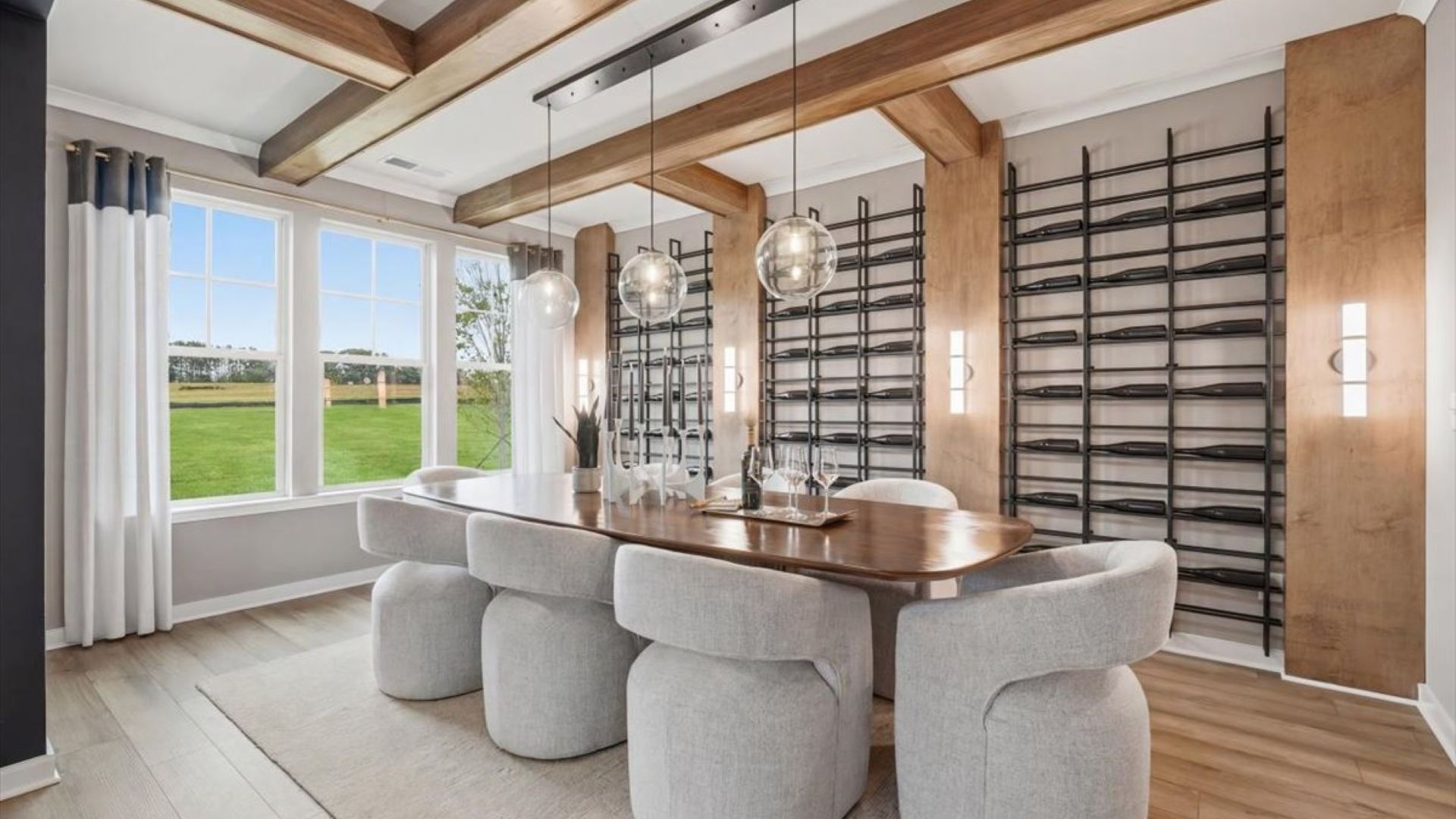 Stonefield dining room with beamed ceiling, LVP flooring, and contemporary finishes at Brighton in Locust Grove, GA.