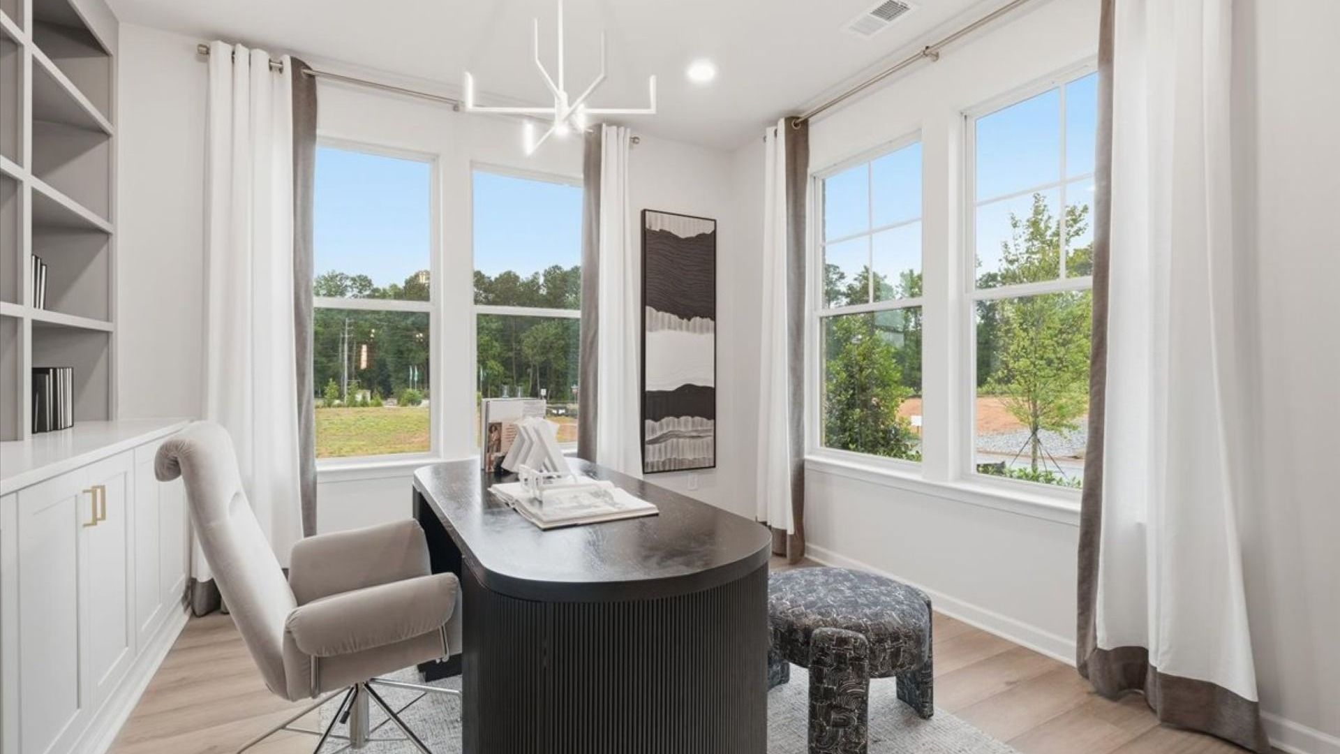 Stonefield office with abundant natural light, built-in shelving, and LVP flooring at Brighton in Locust Grove, GA.