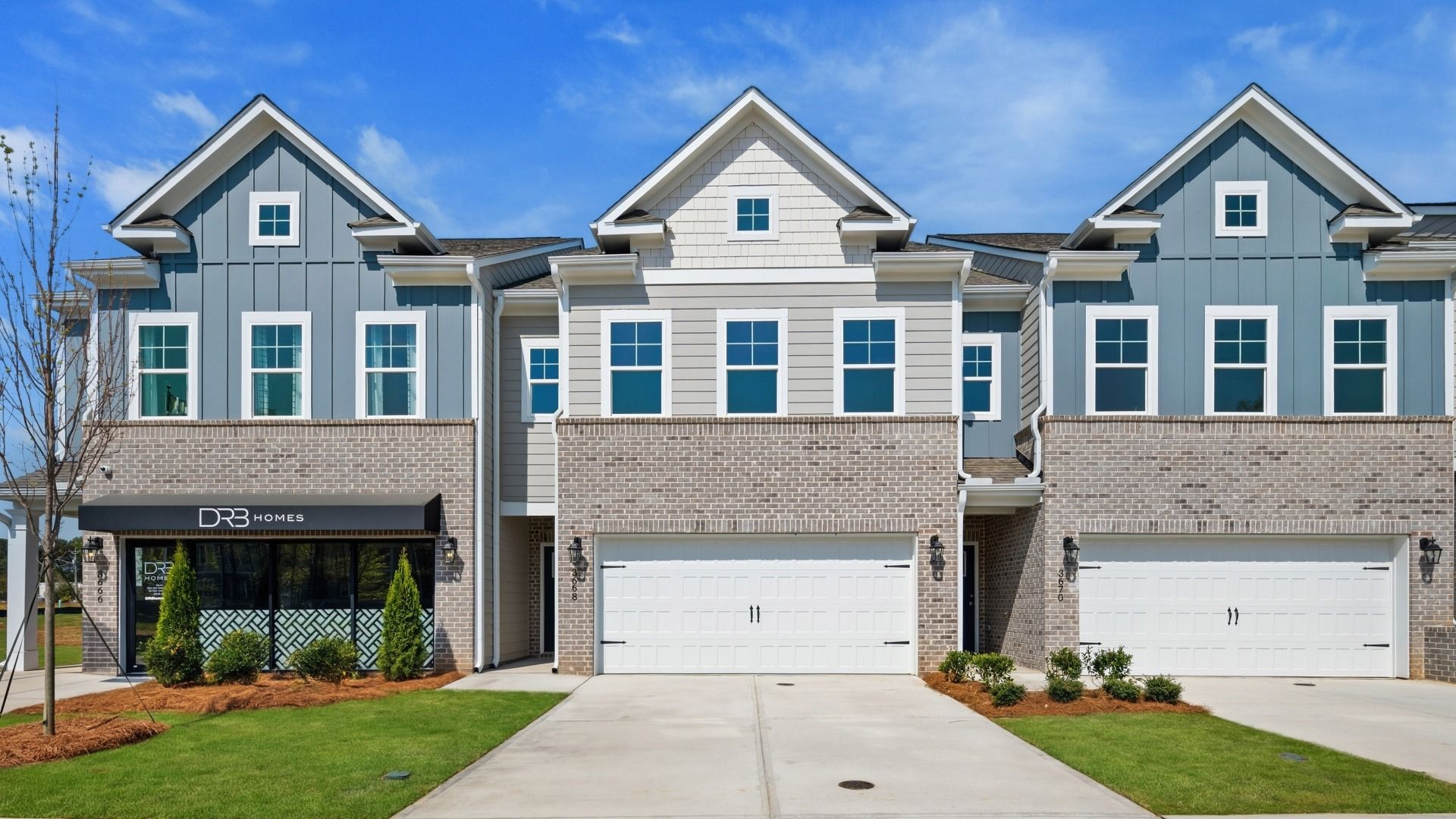 New construction townhomes with brick accents and 2-car garages at Langley Overlook in Loganville, GA.