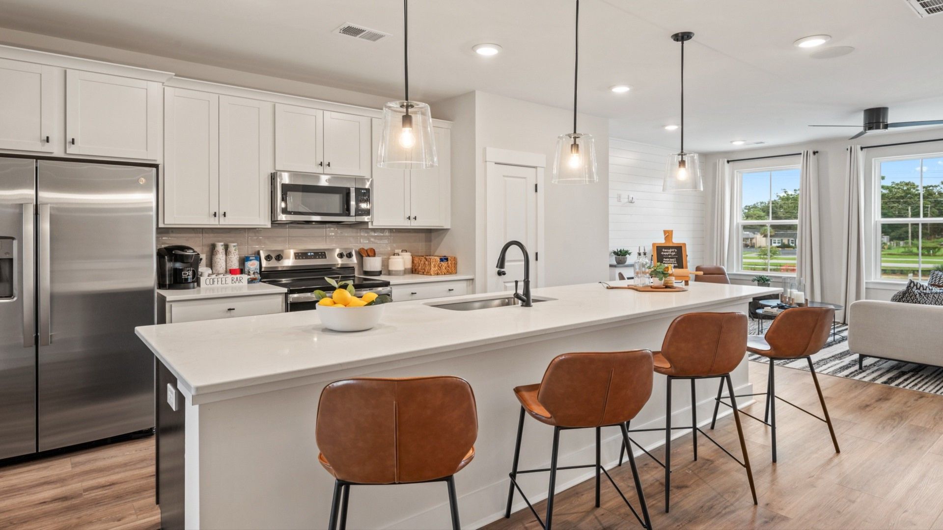 Kitchen island with seating, pendant lights, and open layout