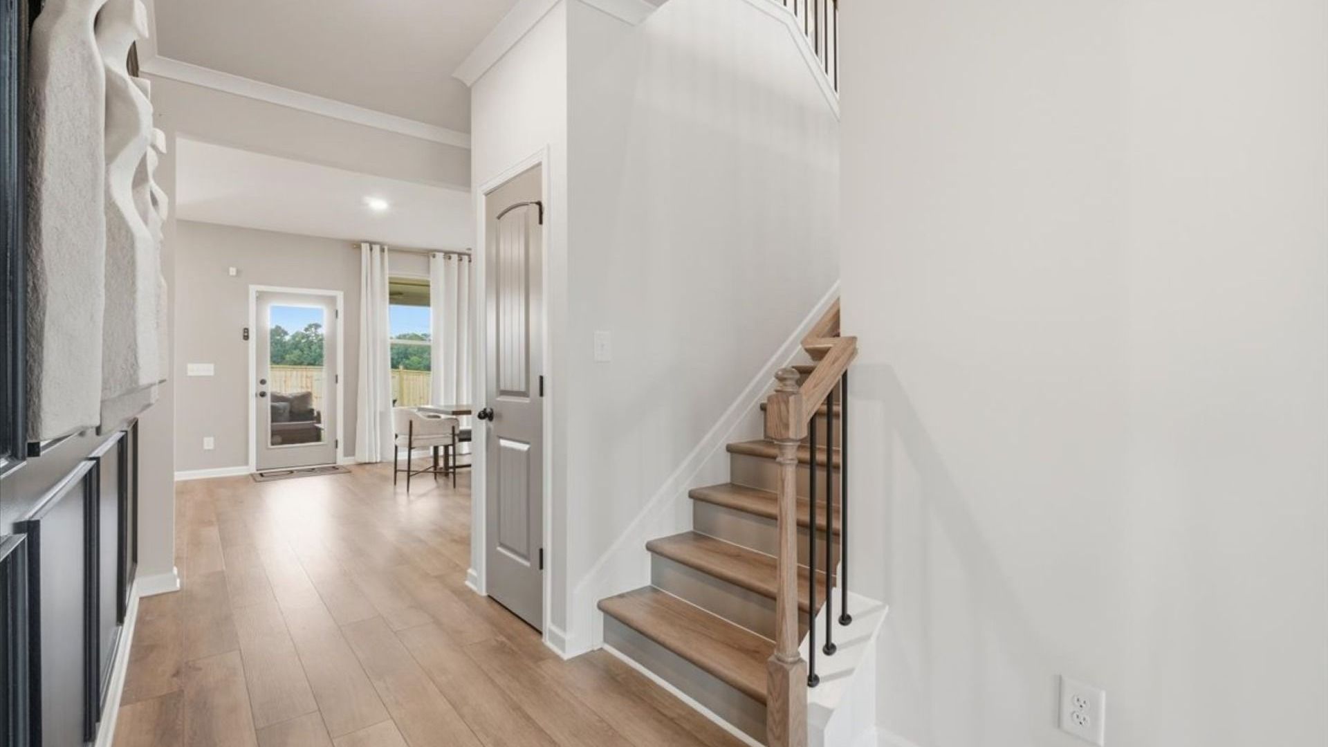 Stonefield open foyer with staircase and LVP flooring at Brighton in Locust Grove, GA.
