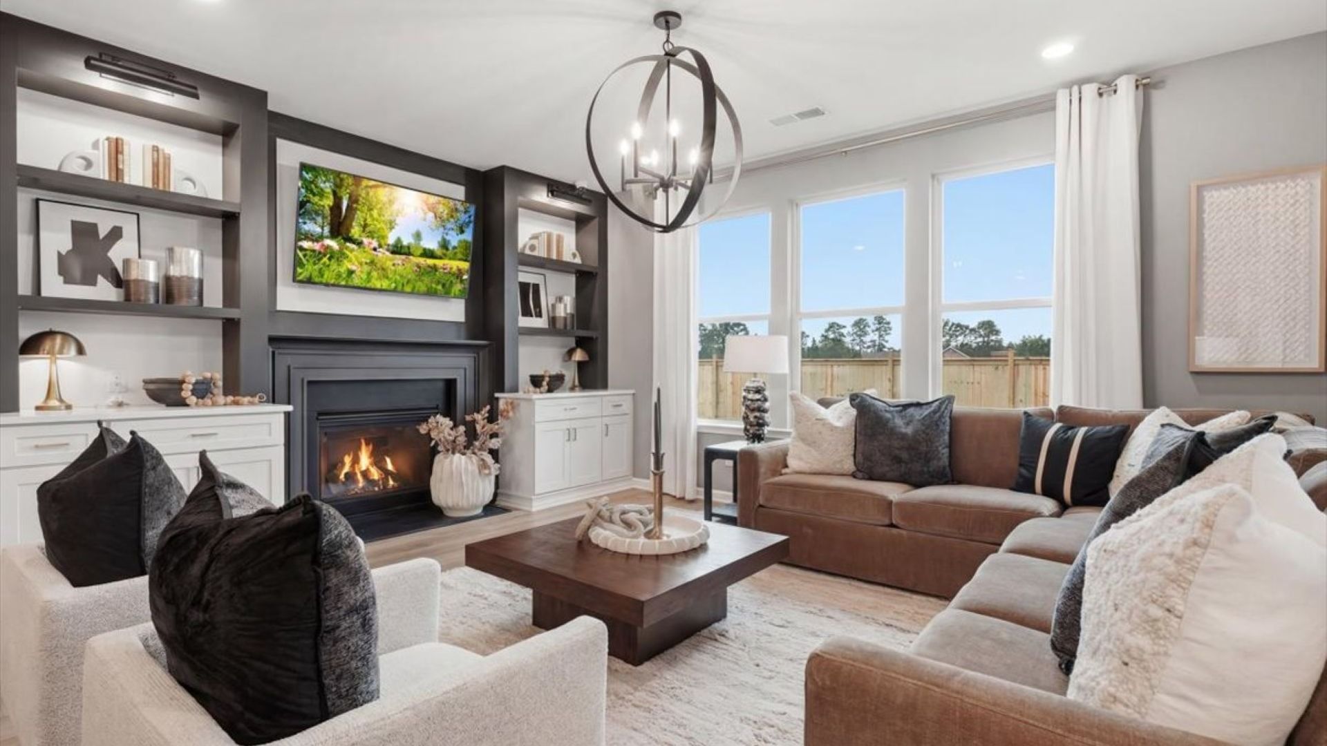 Stonefield family room with gas fireplace, built-in shelving, and additional cabinetry for storage at Brighton.