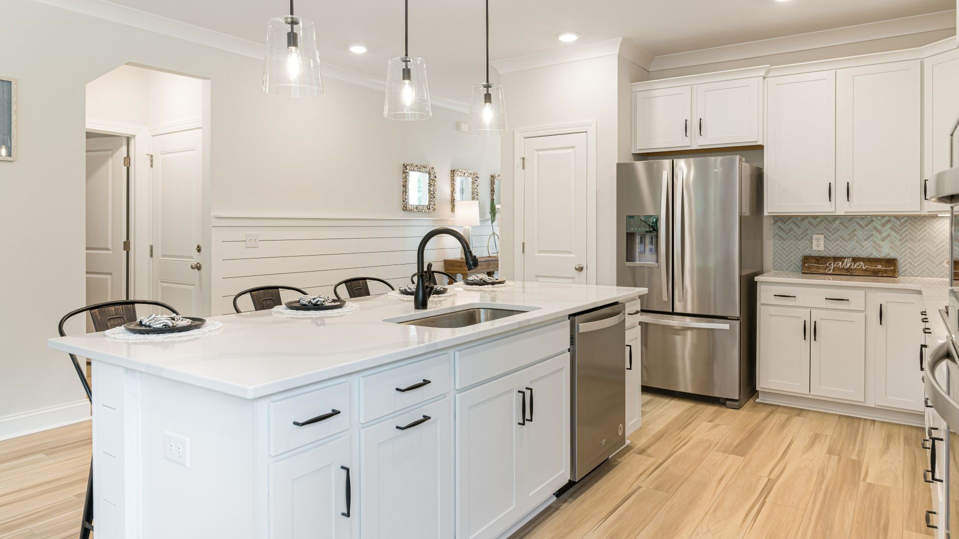gorgeous island with tons of seating in expansive kitchen with stainless steel appliances