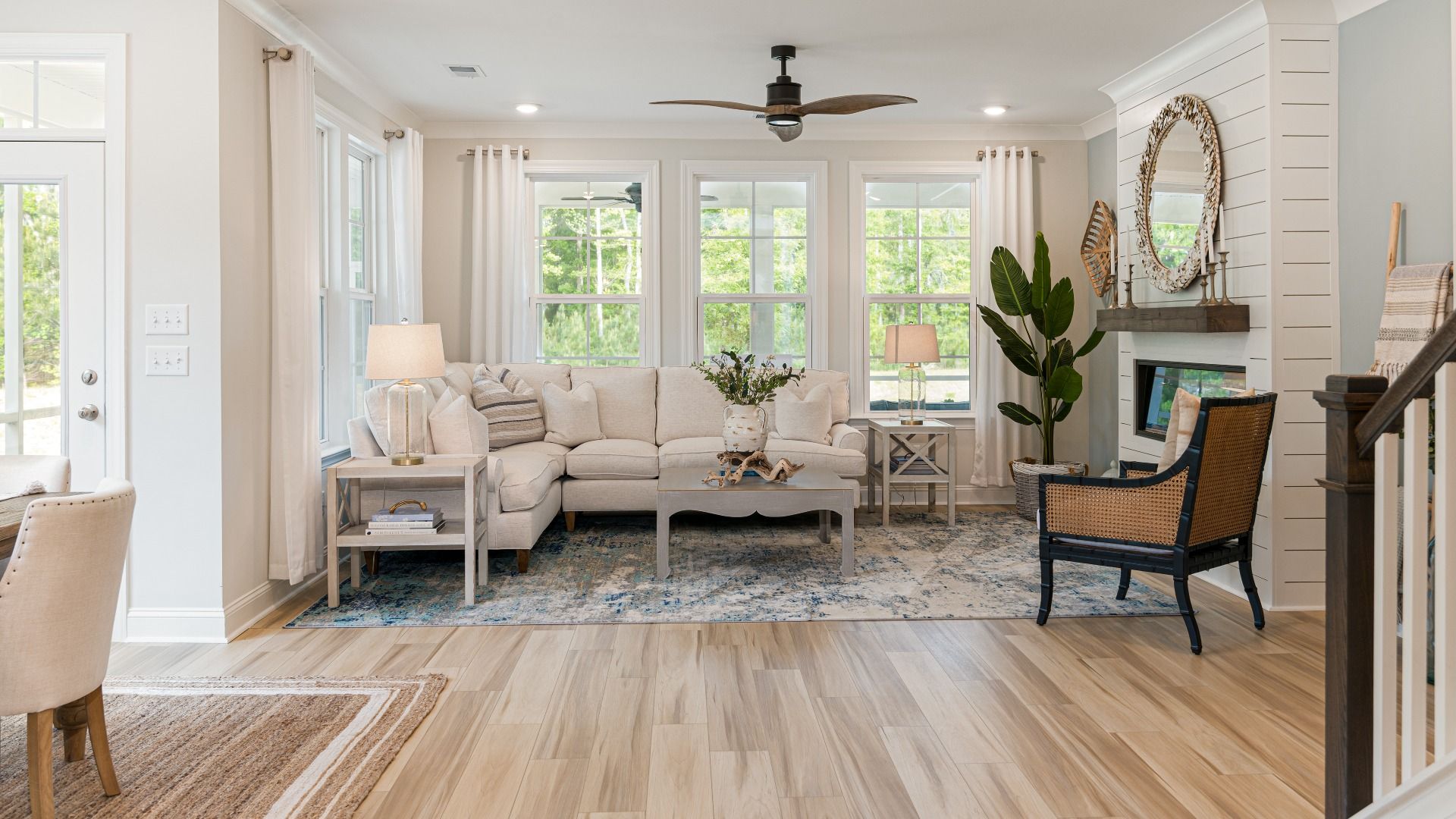 large living room with seating and cozy shiplap fireplace
