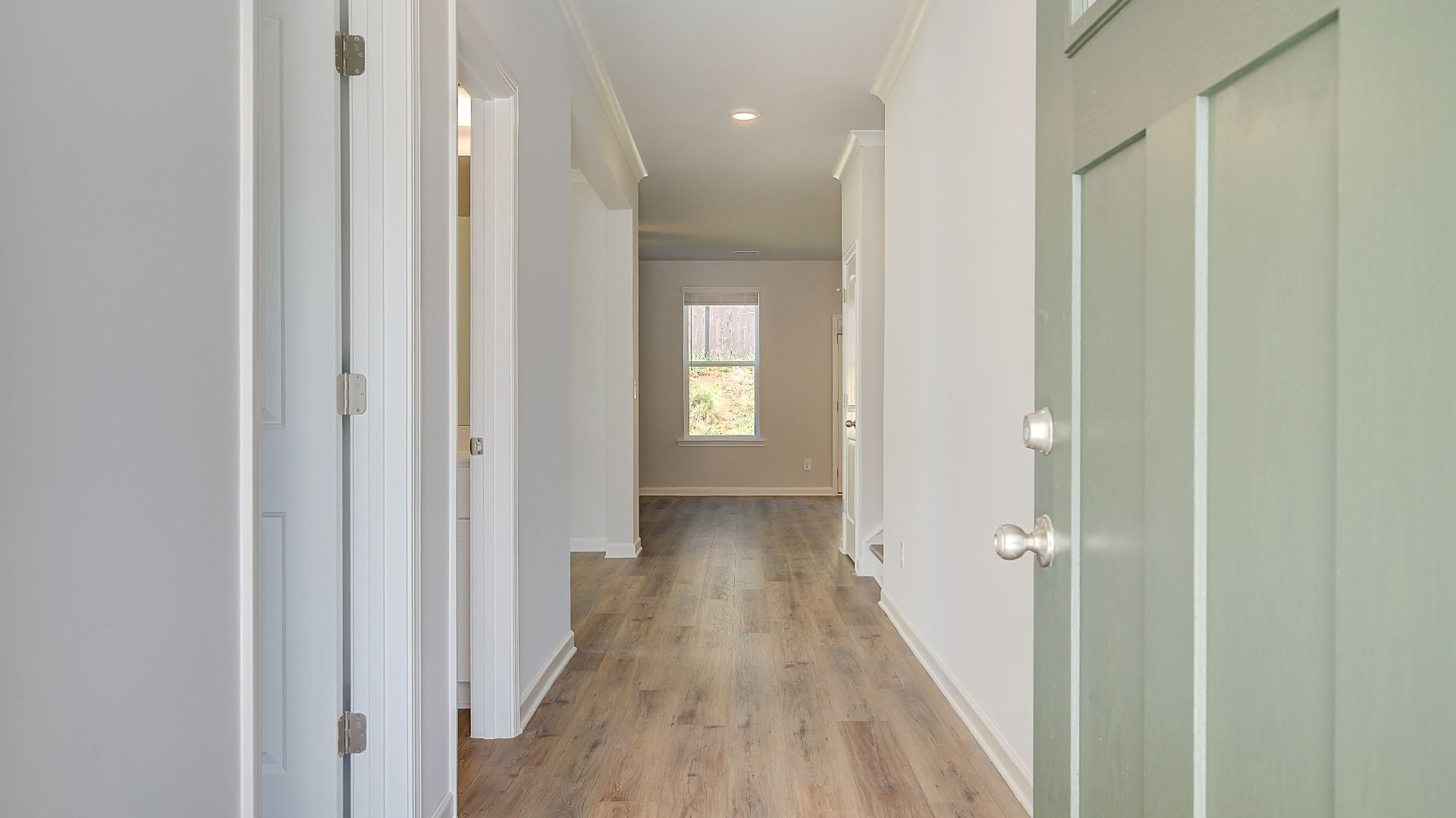 Bright Wagener entryway featuring open foyer with LVP flooring at Bowers Farm in McDonough, GA.