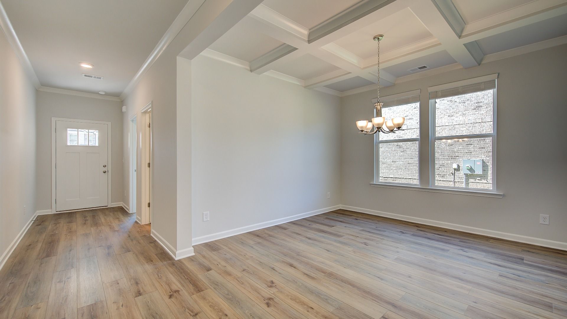 Elegant Wagener dining room with coffered ceiling, LVP flooring, and modern finishes at Bowers Farm in McDonough, GA.