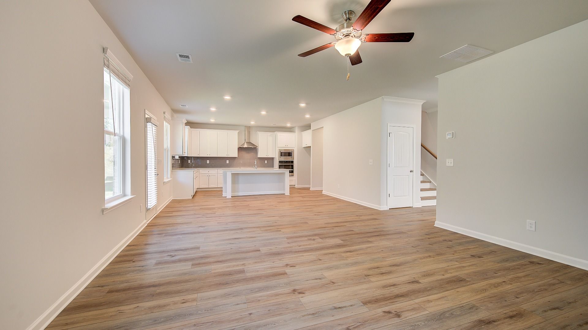 Wagener expansive family room with LVP flooring, views to breakfast area and kitchen, and modern finishes at Bowers Farm.