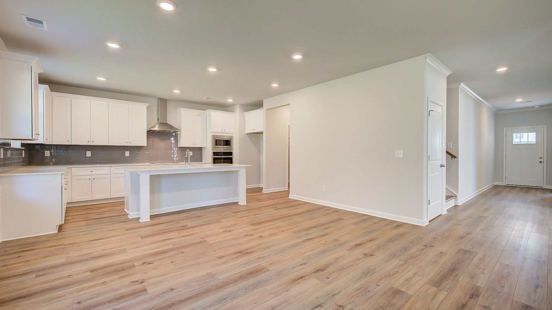 Spacious open breakfast area with view to backyard featuring LVP flooring in the Wagener at Bowers Farm in McDonough, GA.