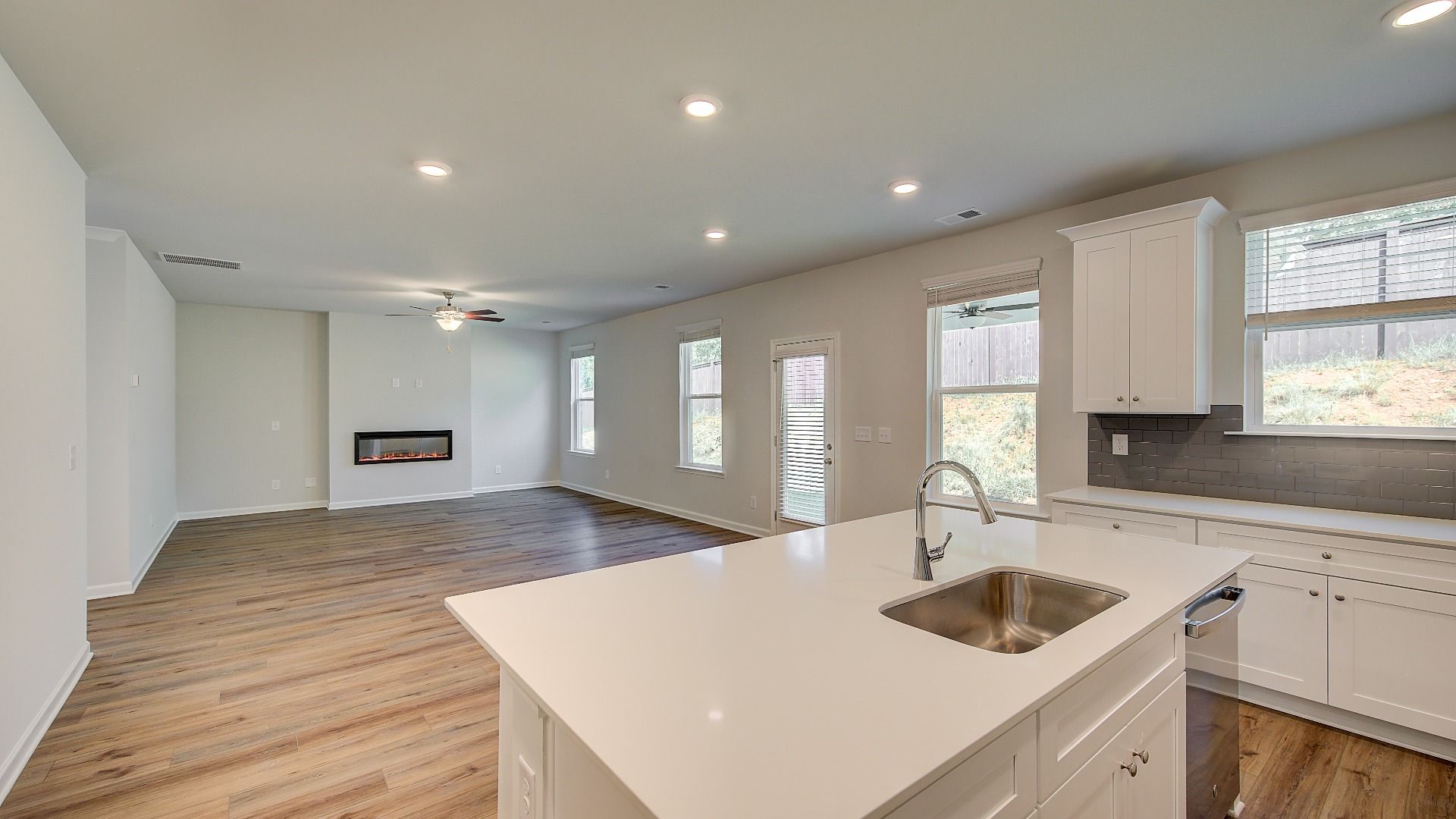 Bright open Wagener kitchen with large center island, pendant lighting, and stainless appliances at Bowers Farm.