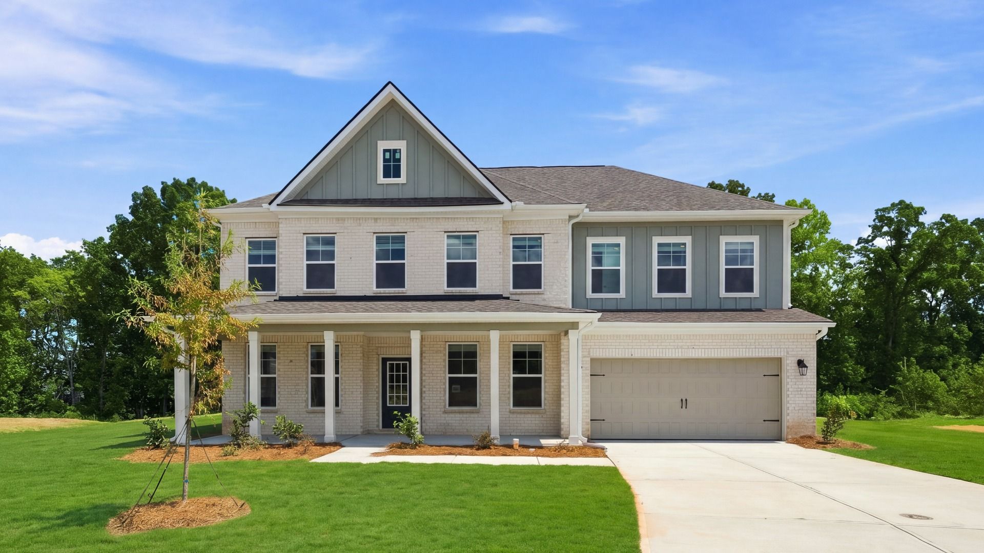 Stonefield two-story estate-sized home with two-car front-entry garage and brick-dominant exterior at Brighton.