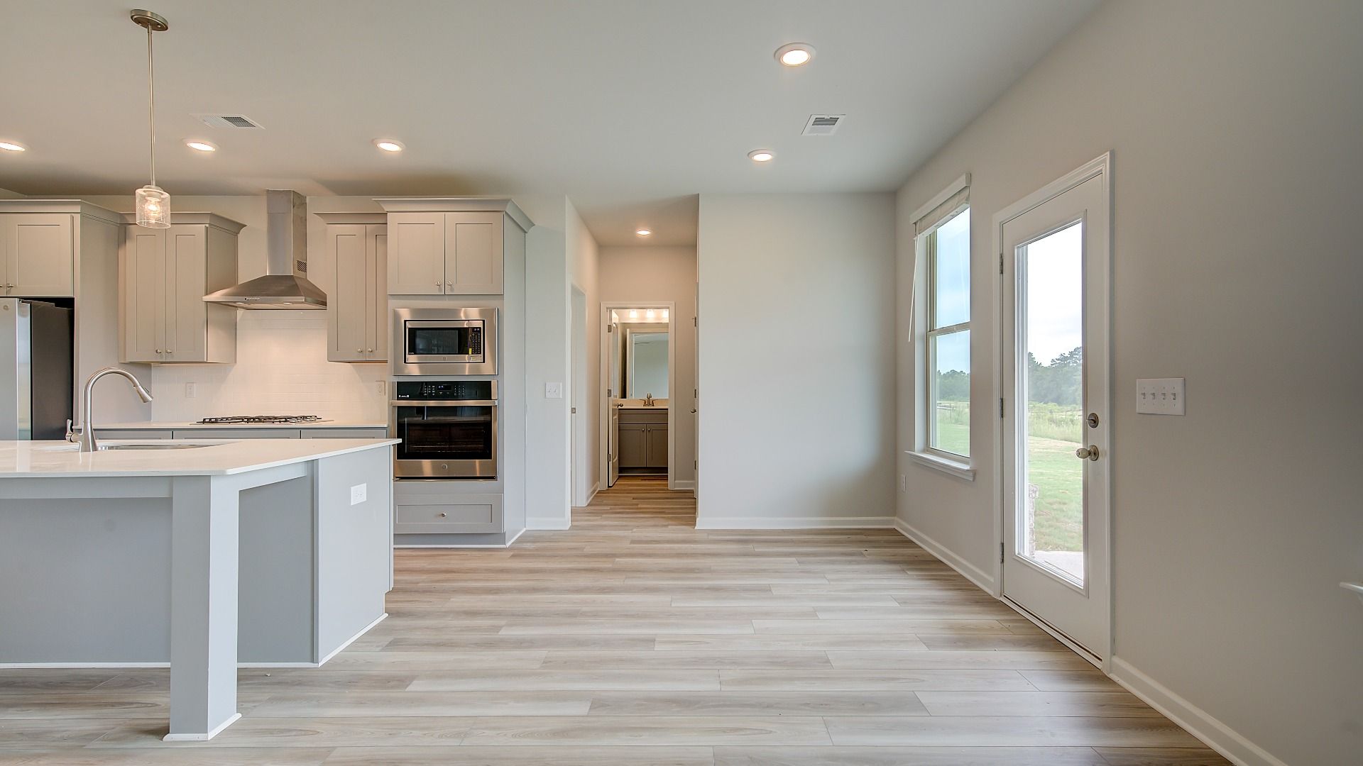 Meridian II breakfast area adjacent to kitchen with natural light and LVP flooring at Brighton in Locust Grove, GA.
