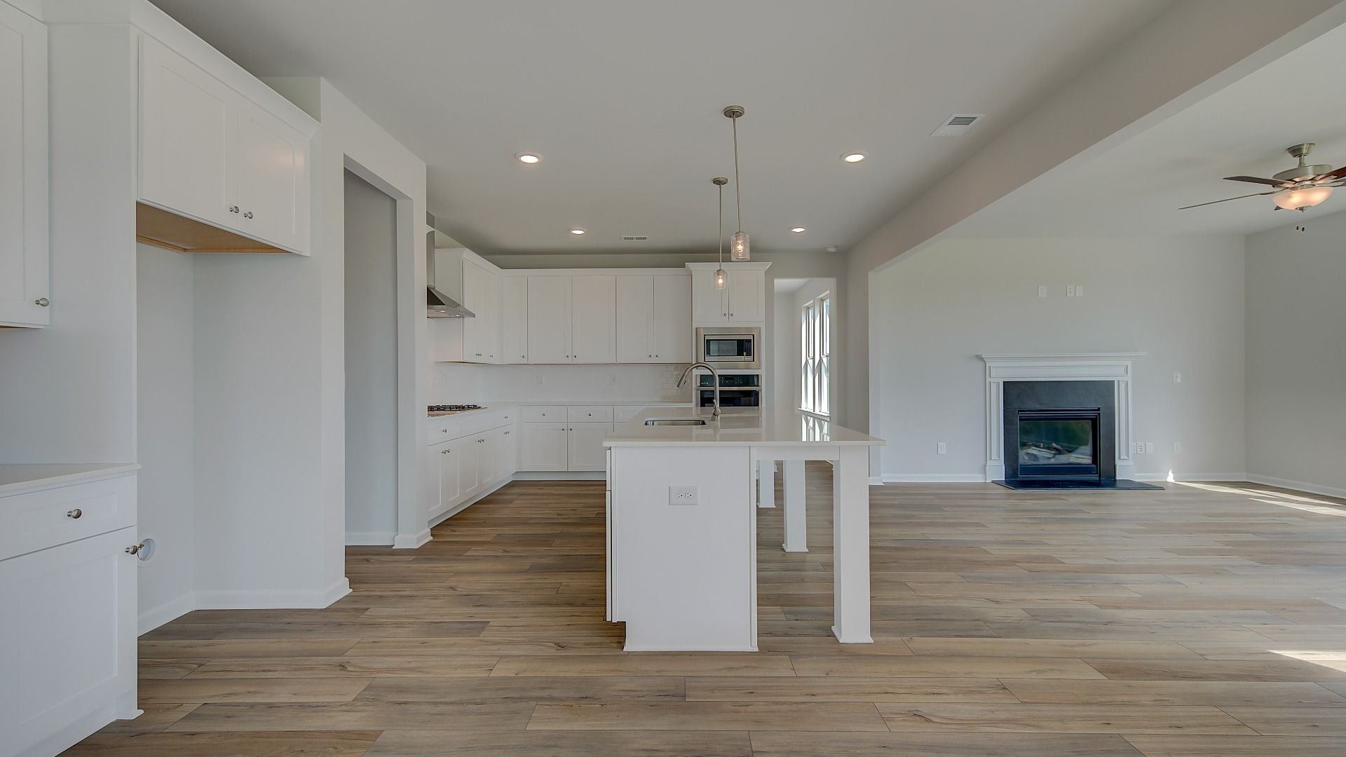 Stonefield open-concept breakfast room with LVP flooring, neutral finishes, and view of kitchen at Brighton.