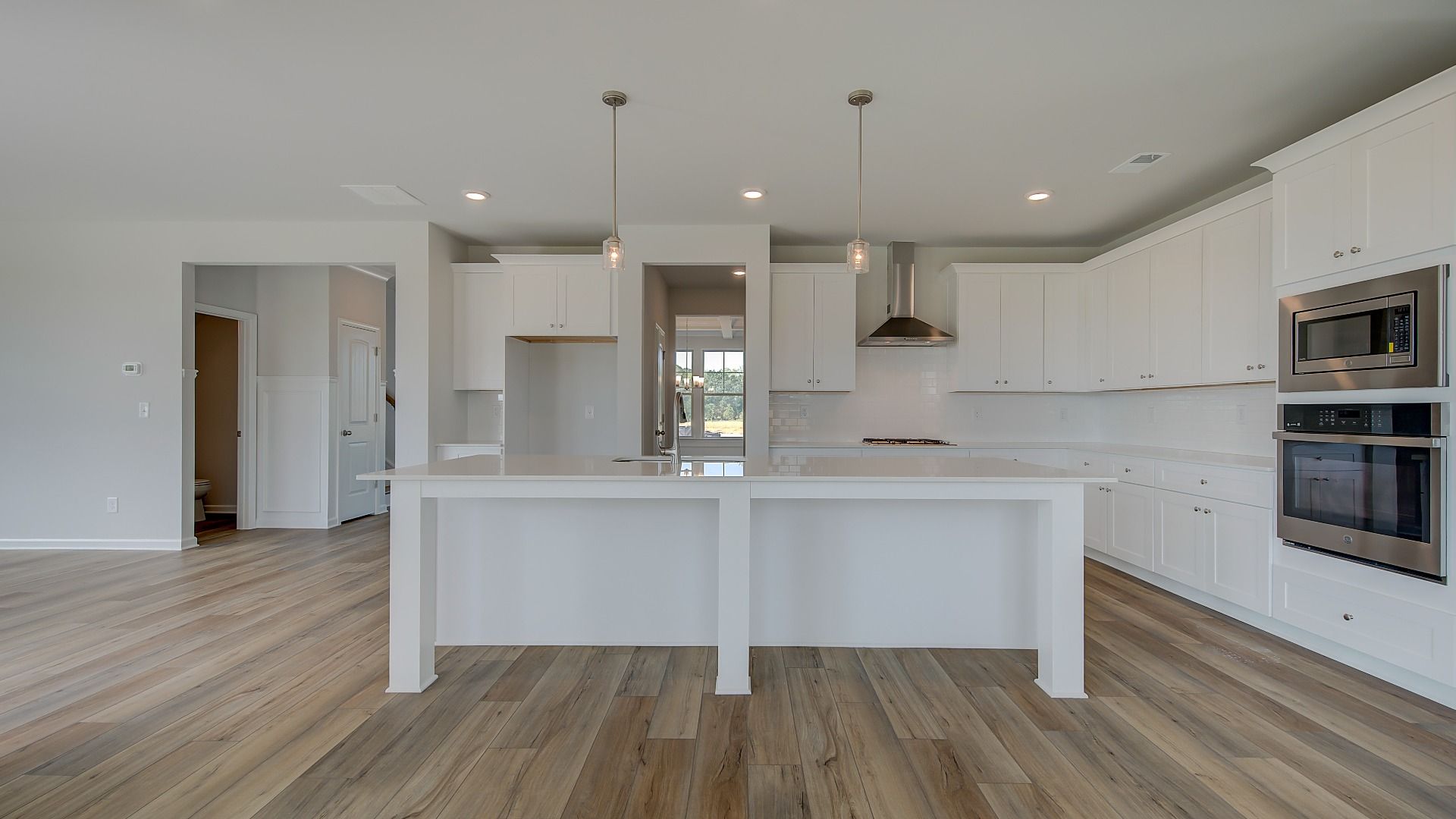 Stonefield open-concept kitchen with expansive island, neutral modern finishes, and pendant lighting at Brighton.