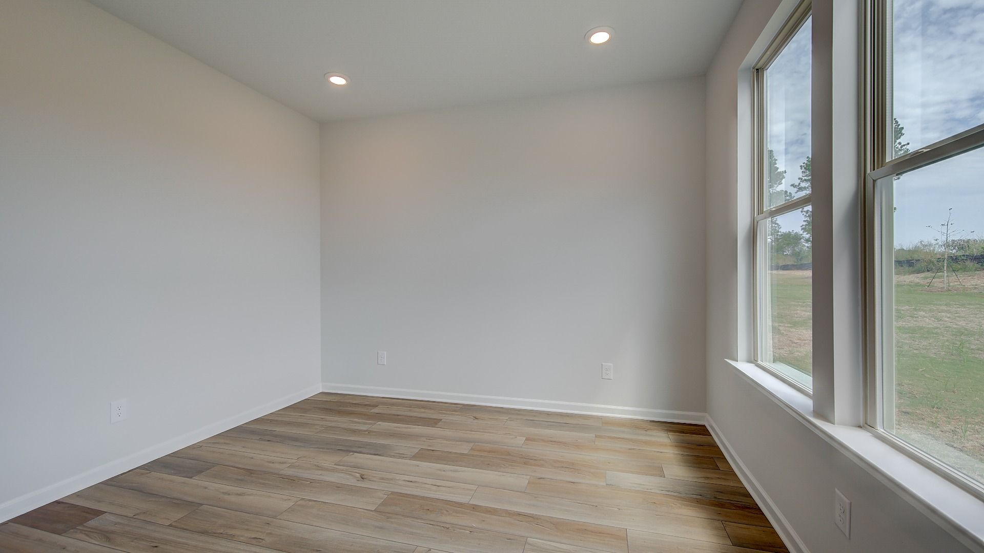 Stonefield secondary bedroom with carpet flooring and connected full bath at Brighton in Locust Grove, GA.