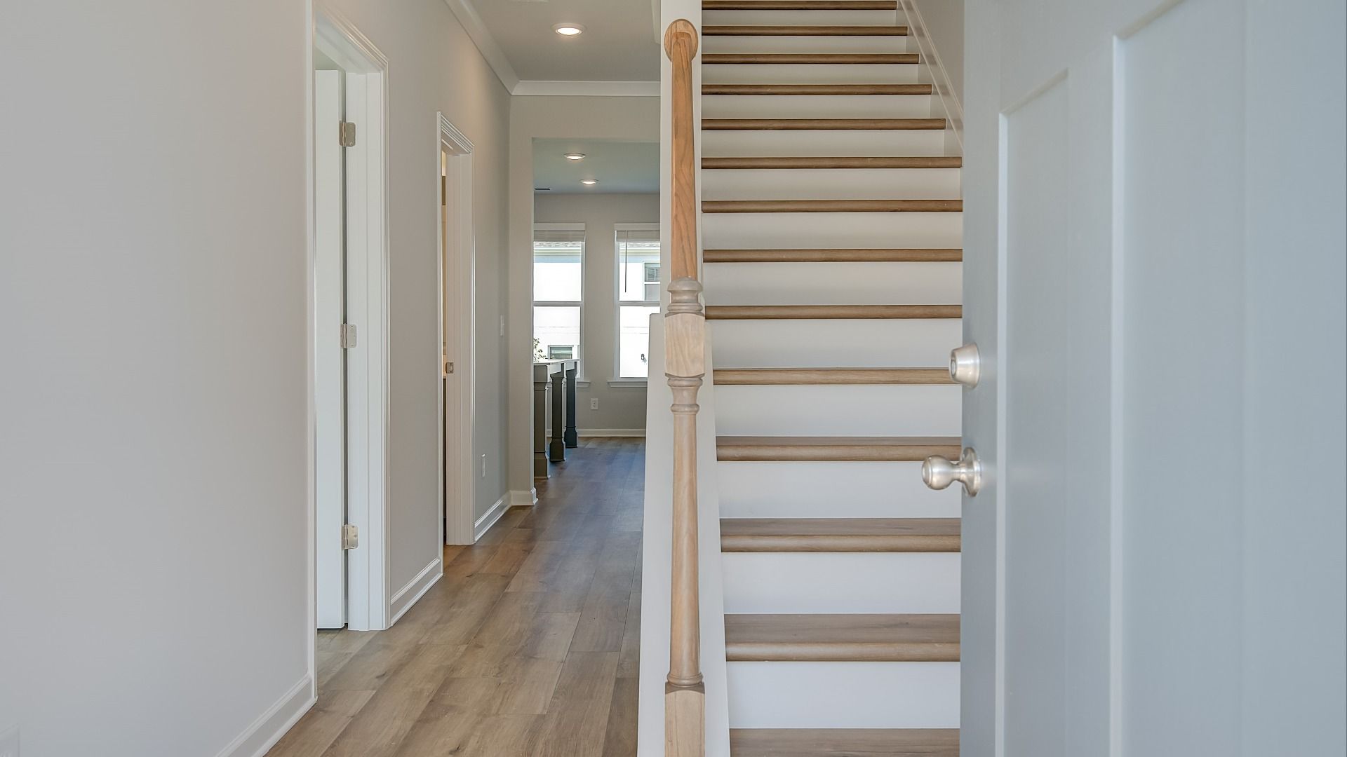 Ridgewood welcoming entry into open foyer and staircase featuring LVP flooring at Bowers Farm in McDonough, GA.
