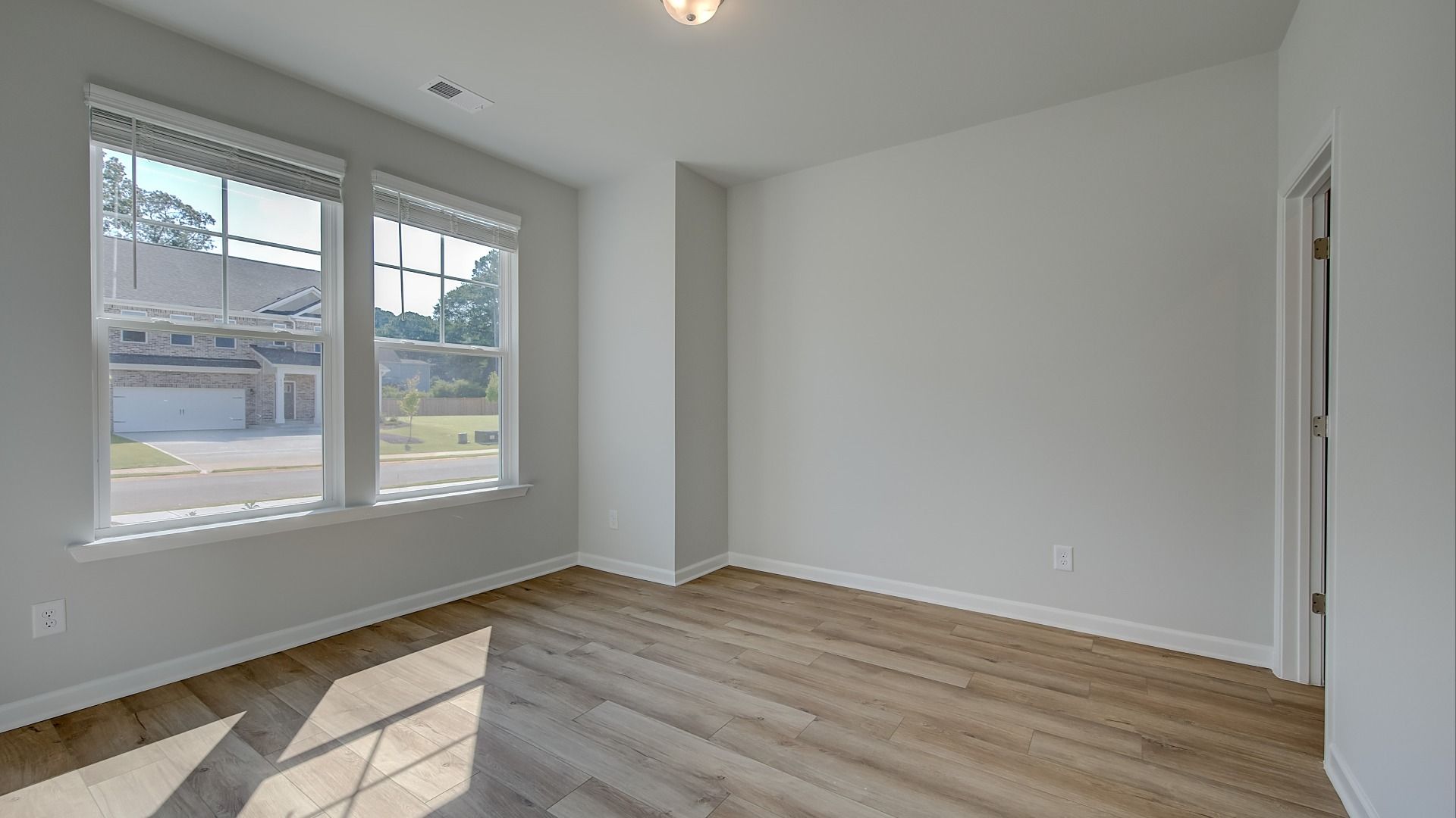 Ridgewood bright flex space with large windows and neutral modern finishes at Bowers Farm in McDonough, GA.