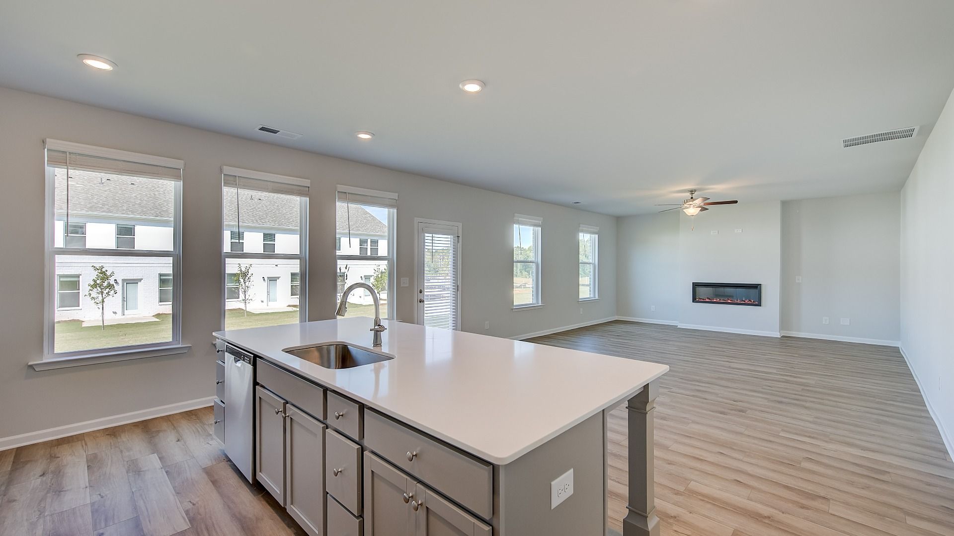 Open-concept Ridgewood kitchen with a center island, and grey cabinetry at Bowers Farm in McDonough, GA.