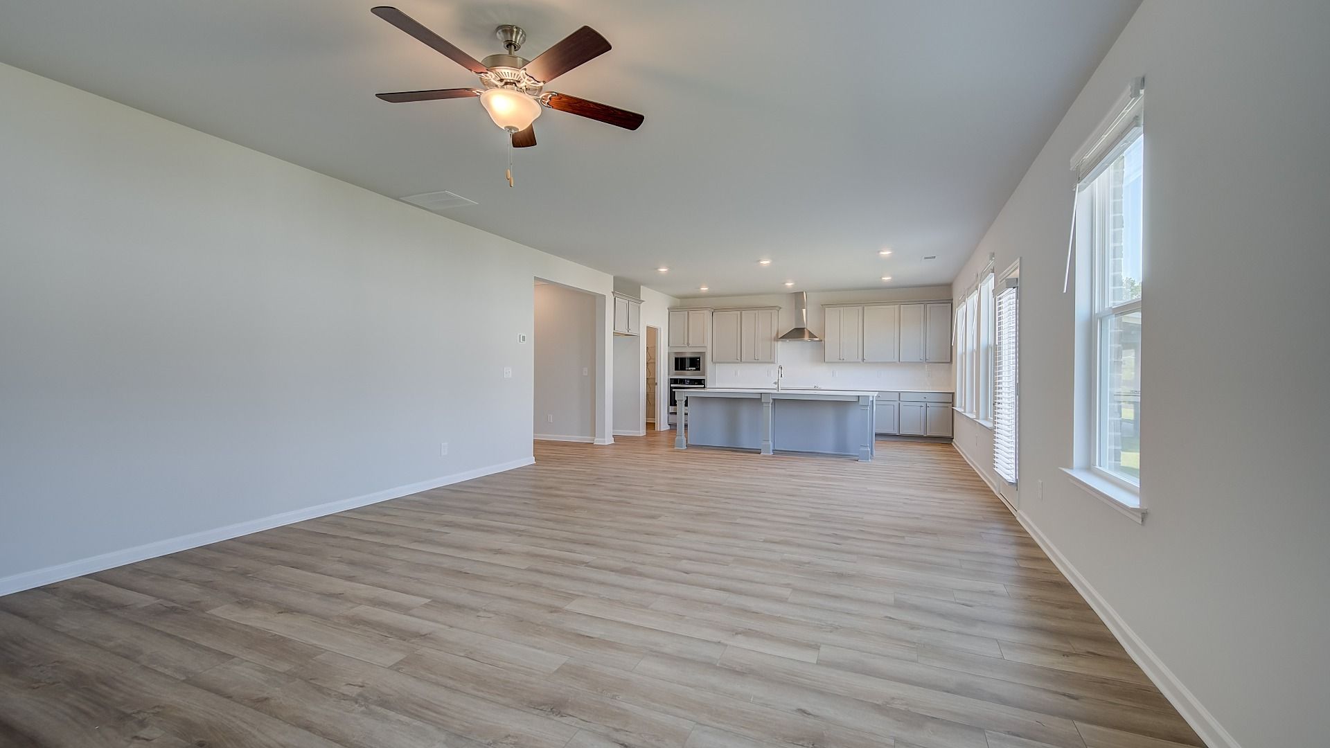 Expansive family room with LVP flooring, natural light, and views to breakfast area and kitchen in Ridgewood at Bowers Farm.