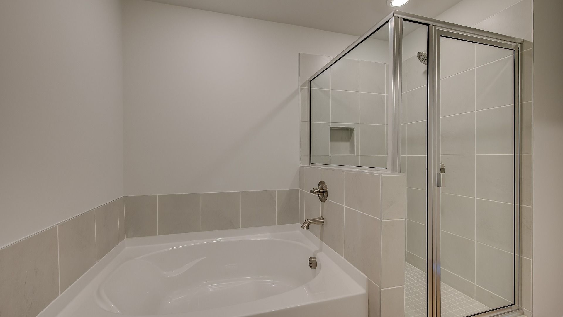 Ridgewood luxury primary bath with spacious tile-wall walk-in shower, tub and walk-in closet at Bowers Farm.