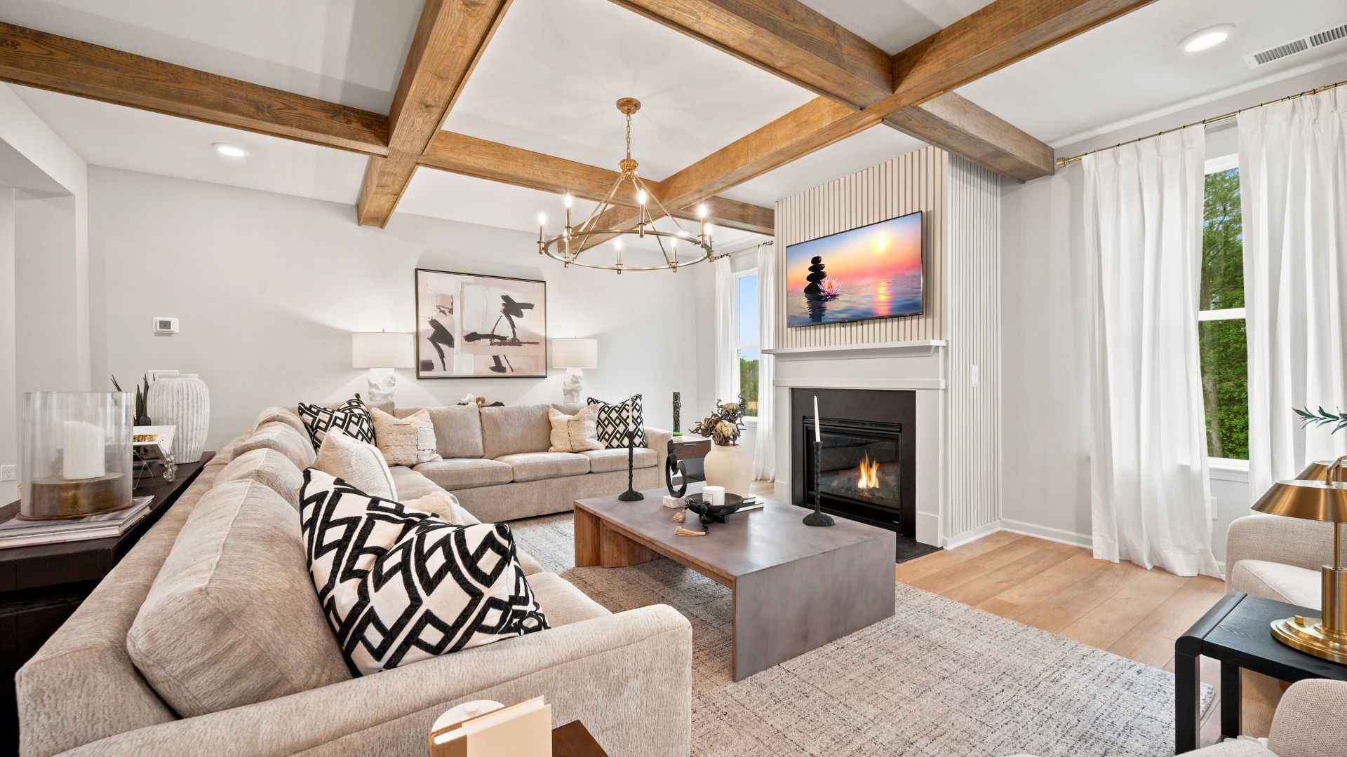Expansive family room with center gas fireplace, natural light, and spacious seating area in the Rosemary II at Brighton.