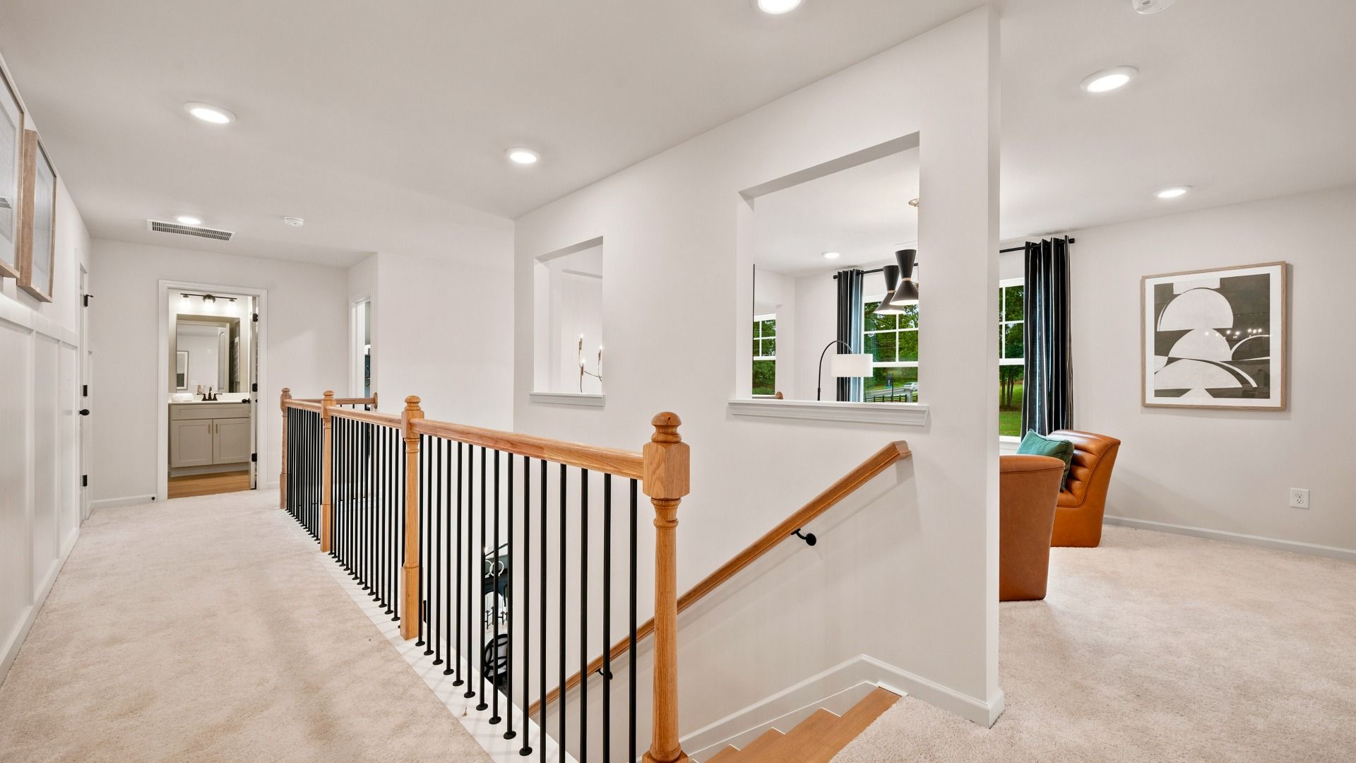 Rosemary II upstairs landing with carpet flooring leading to open hallway and loft area at Brighton in Locust Grove, GA.