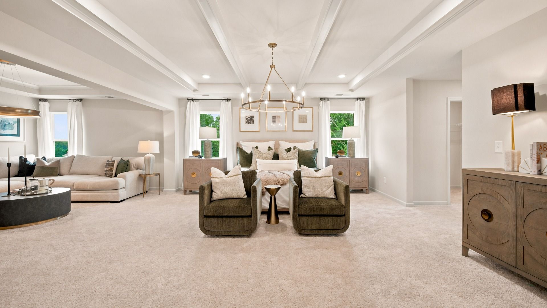 Rosemary II primary suite with carpet flooring, sitting room, and connected primary bath at Brighton in Locust Grove, GA.