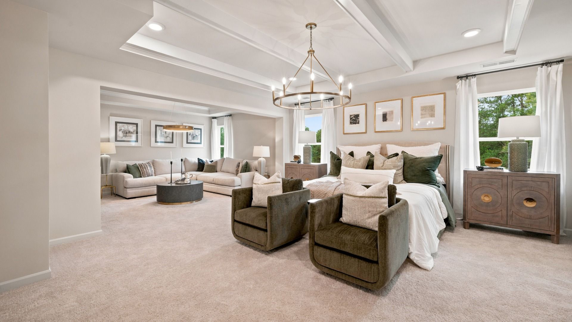 Rosemary II primary suite with carpet flooring, sitting room, and connected primary bath at Brighton in Locust Grove, GA.