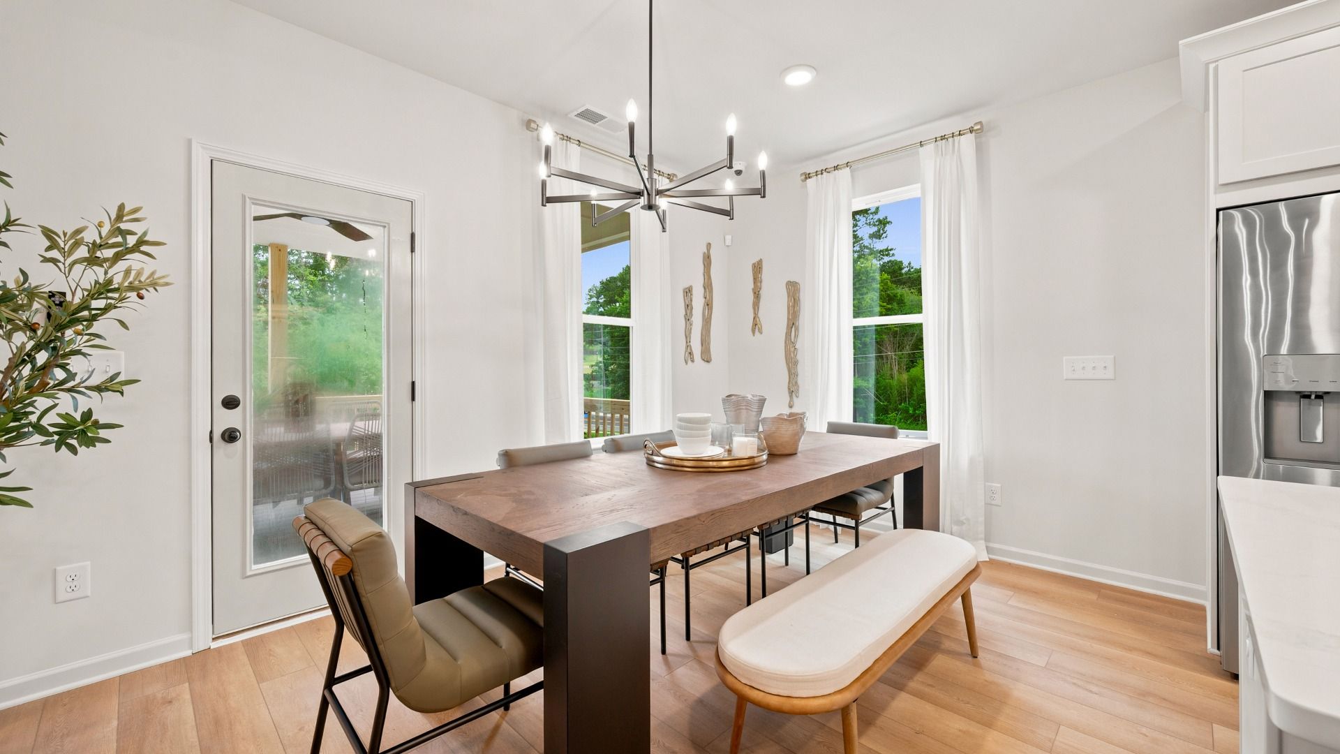 Rosemary II breakfast area adjacent to kitchen with natural light and views of family room and porch at Brighton.