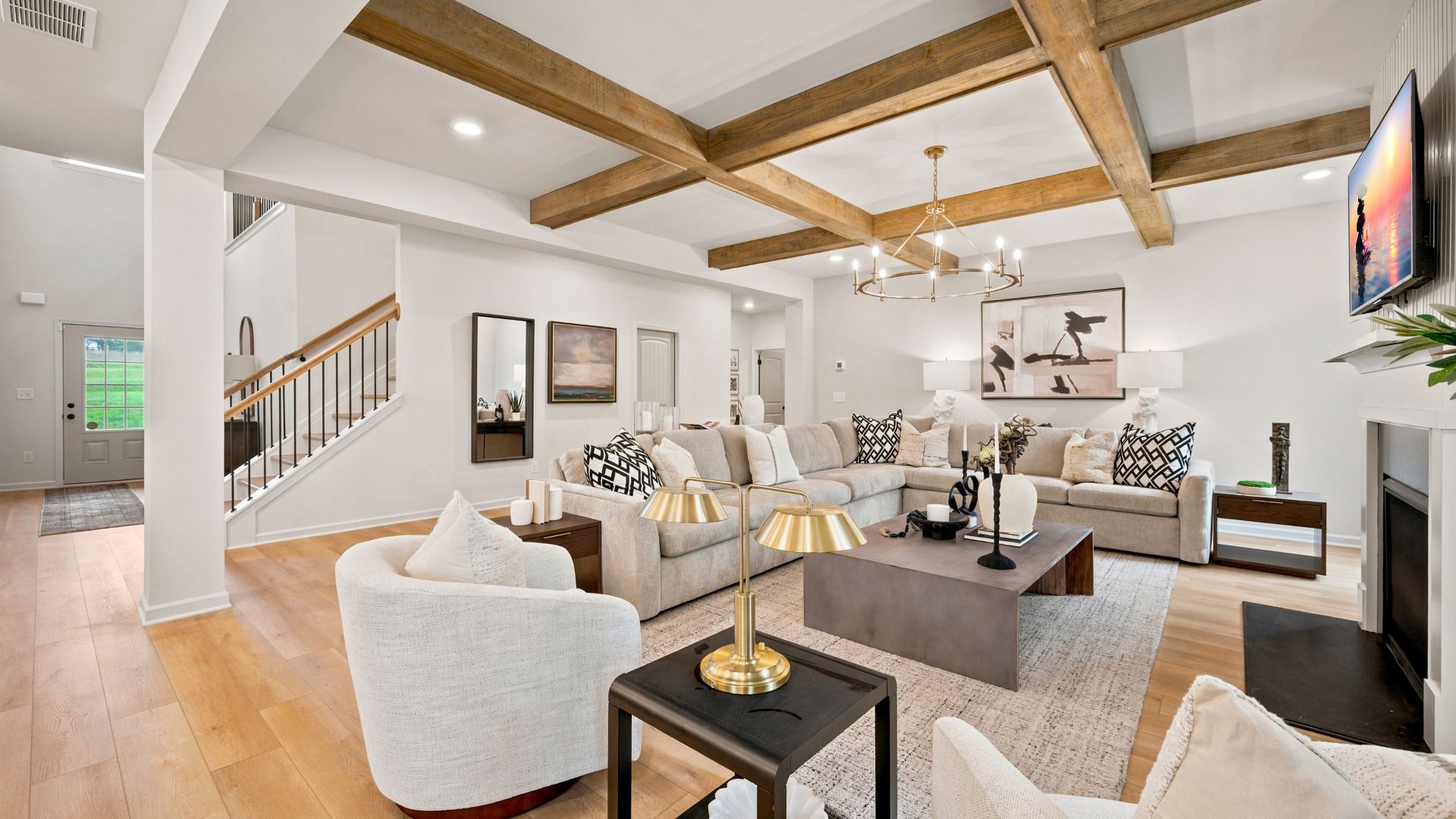 Open family room with center gas fireplace, natural light, and spacious seating area in the Rosemary II at Brighton.