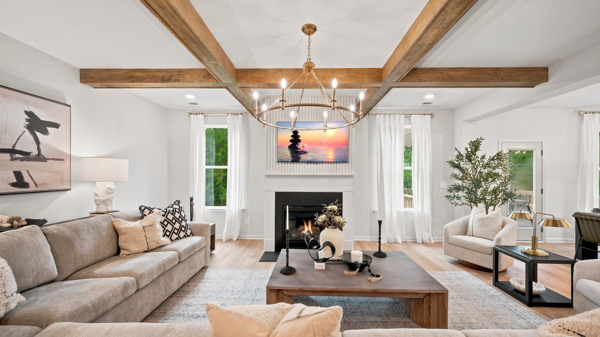 Open-concept family room with LVP flooring and views of kitchen and breakfast area in the Rosemary II at Brighton.